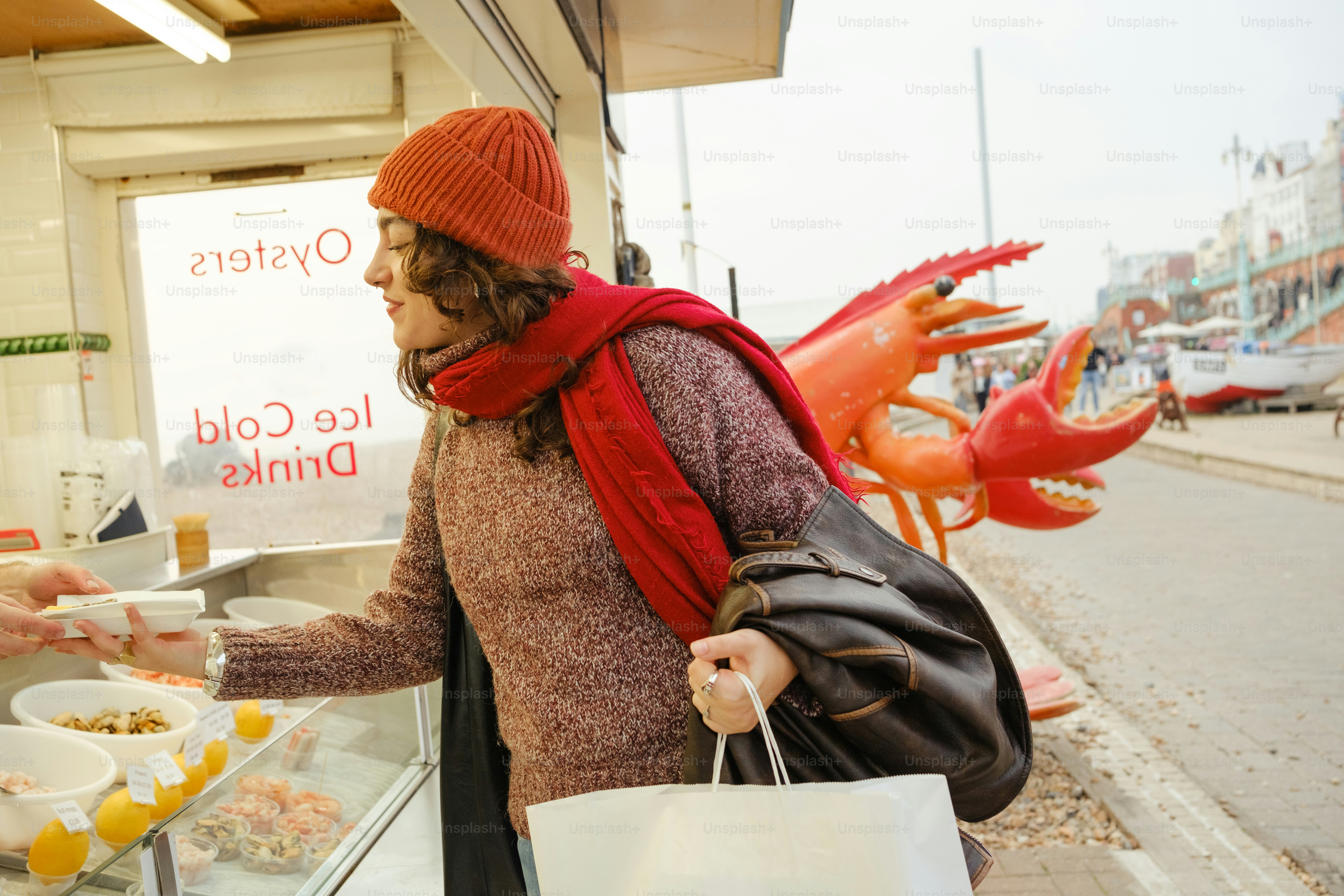 A woman is handing out food to a man
