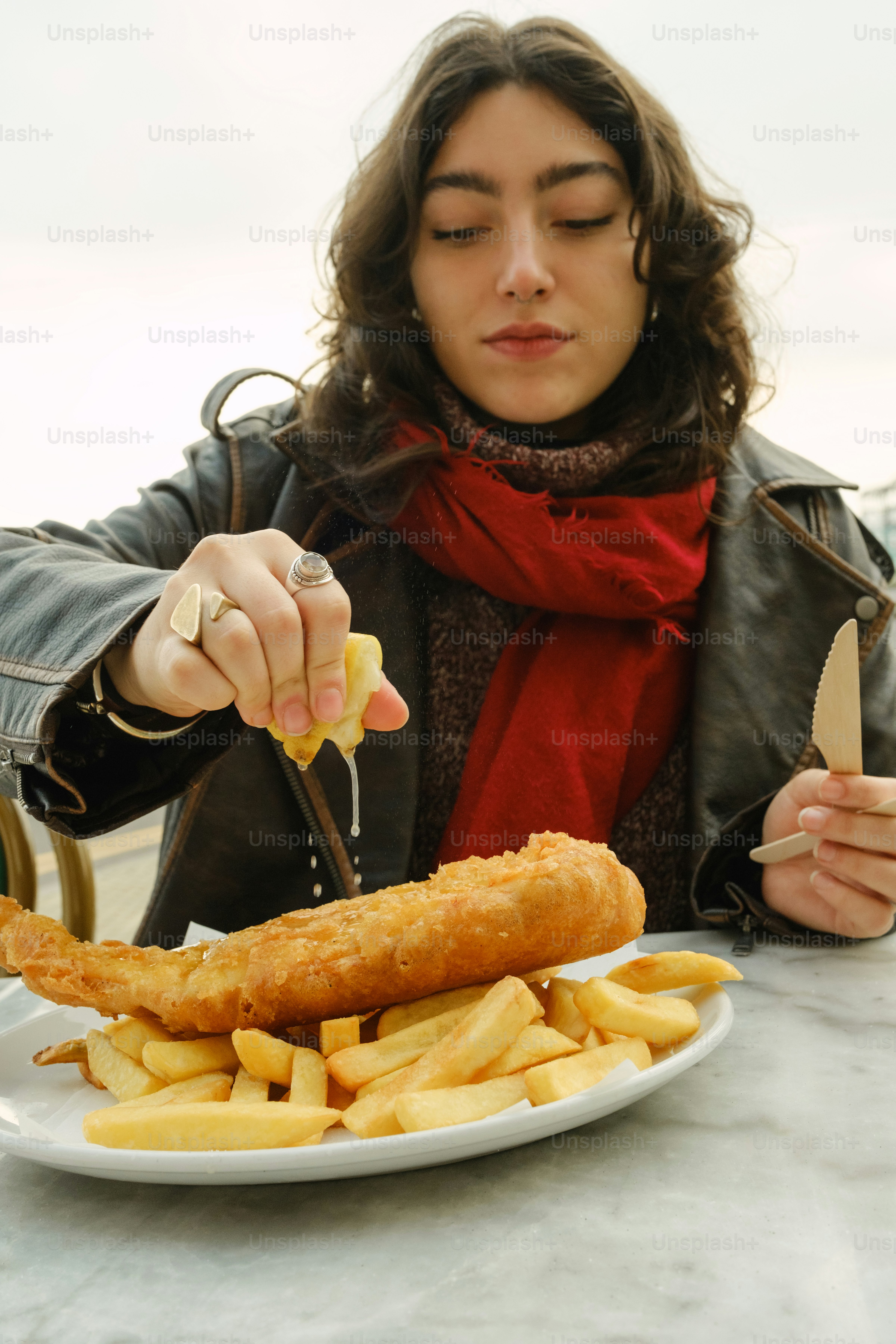 A woman sitting at a table with a plate of food