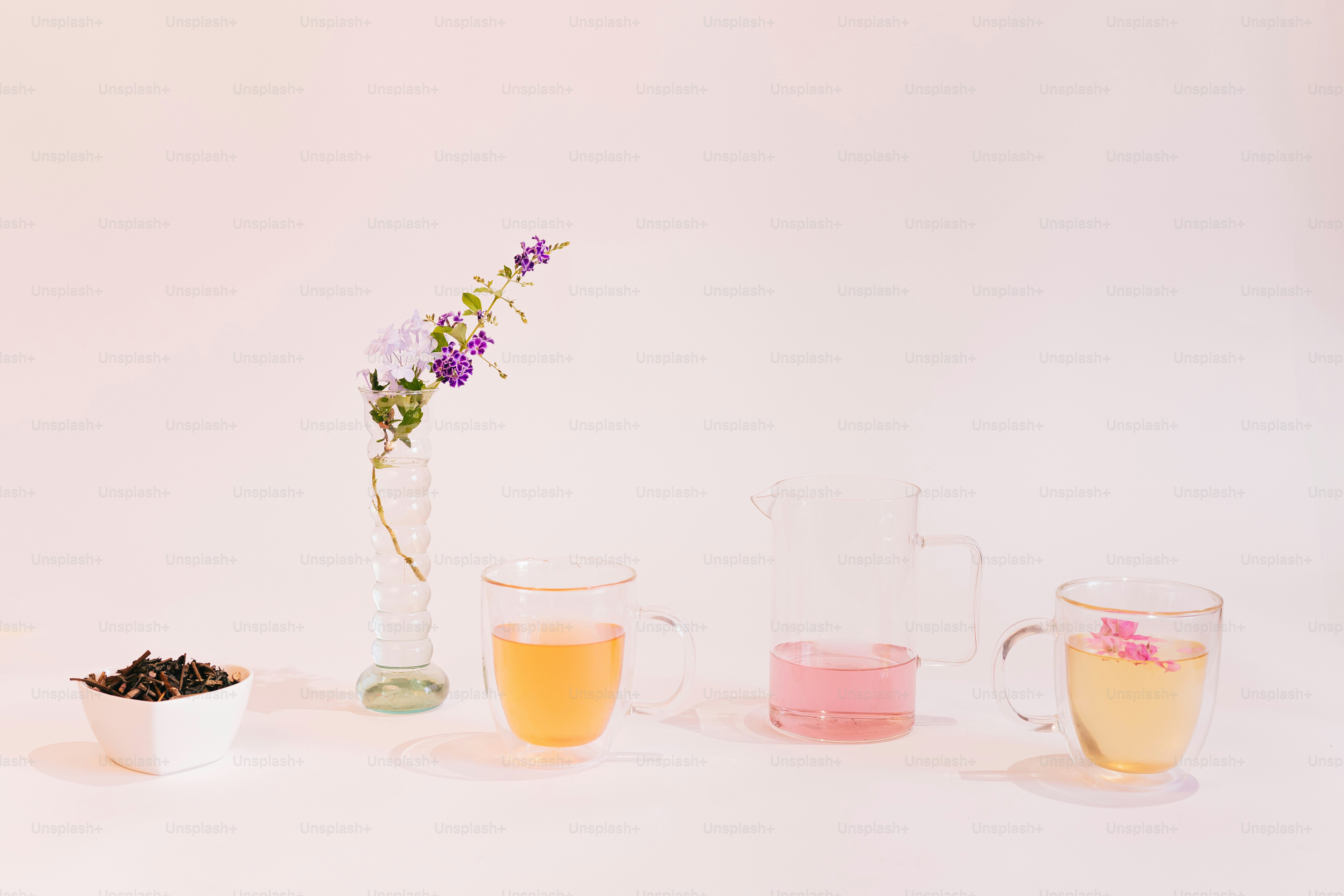 A white table topped with glasses filled with liquid