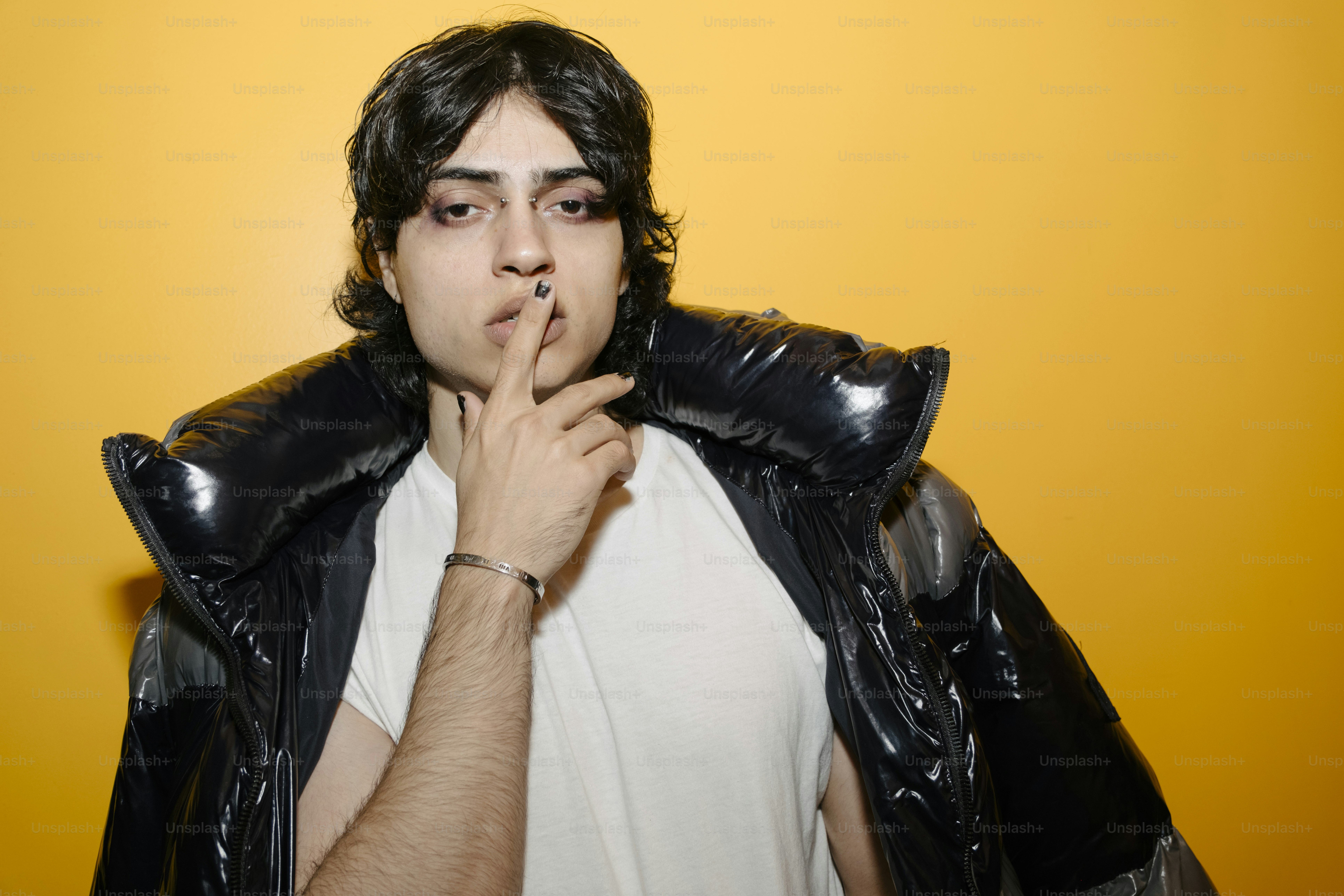 A man in a white shirt and black leather jacket