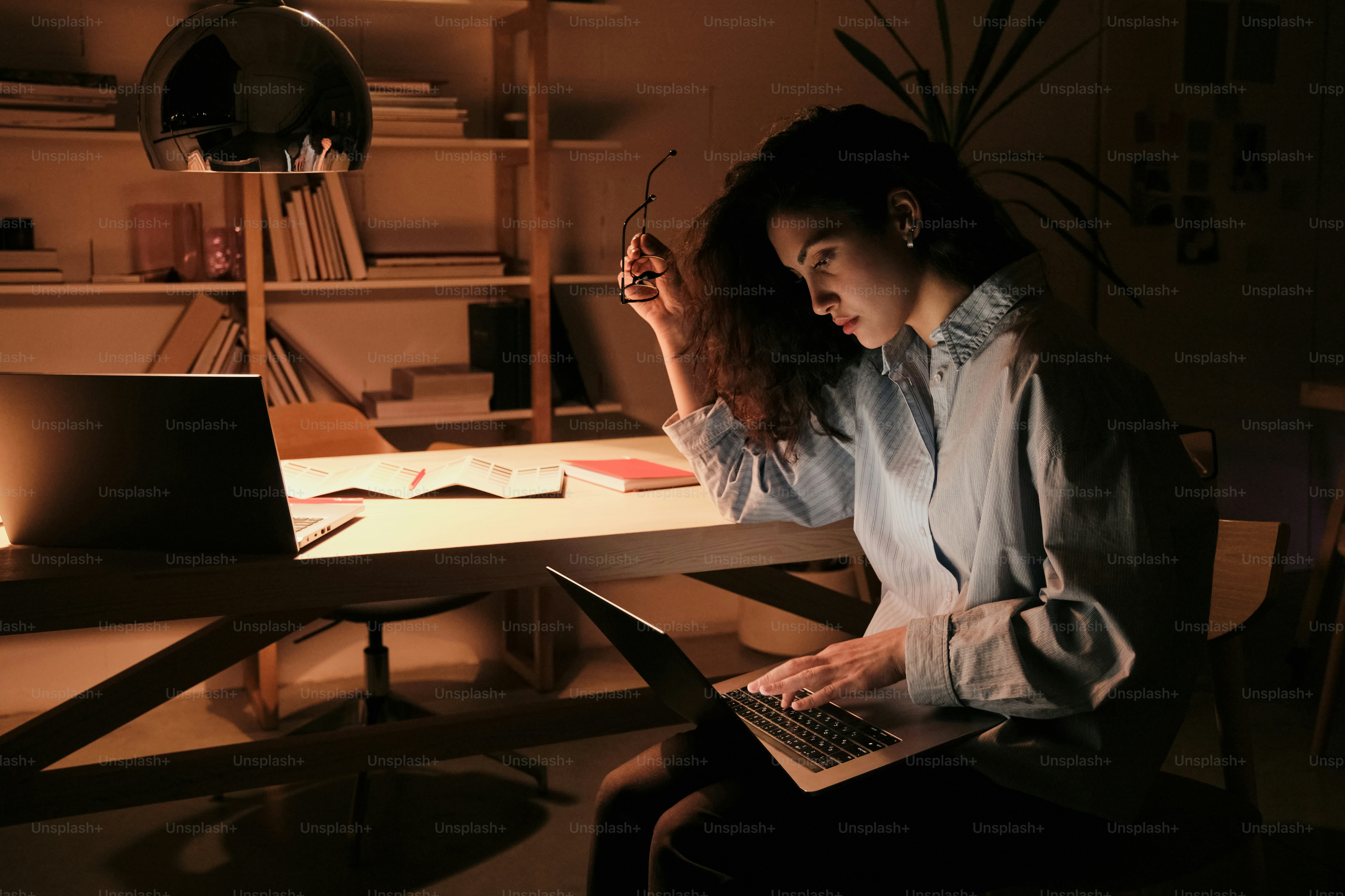 A woman sitting in front of a laptop computer