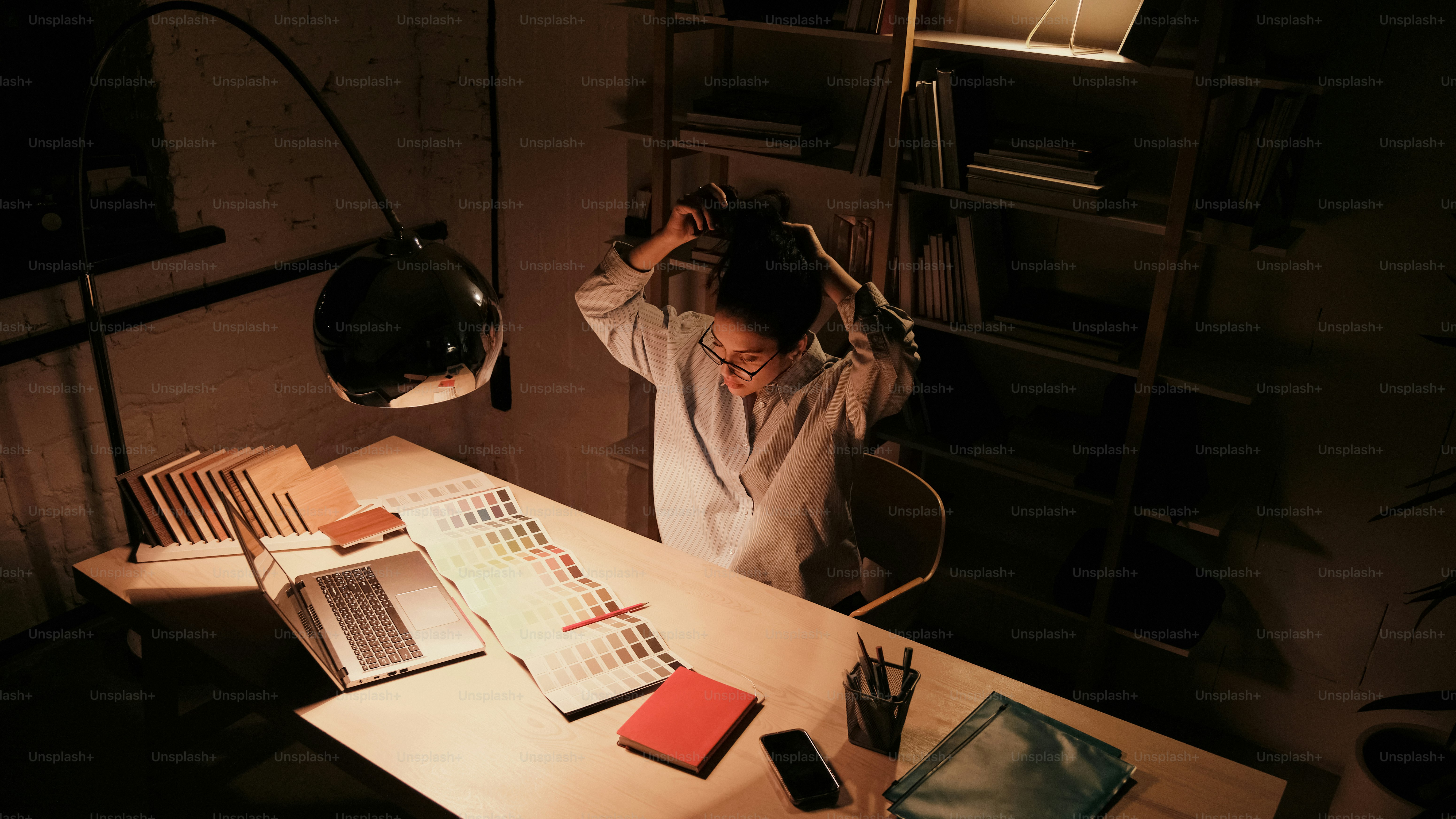 A person sitting at a desk in a dark room