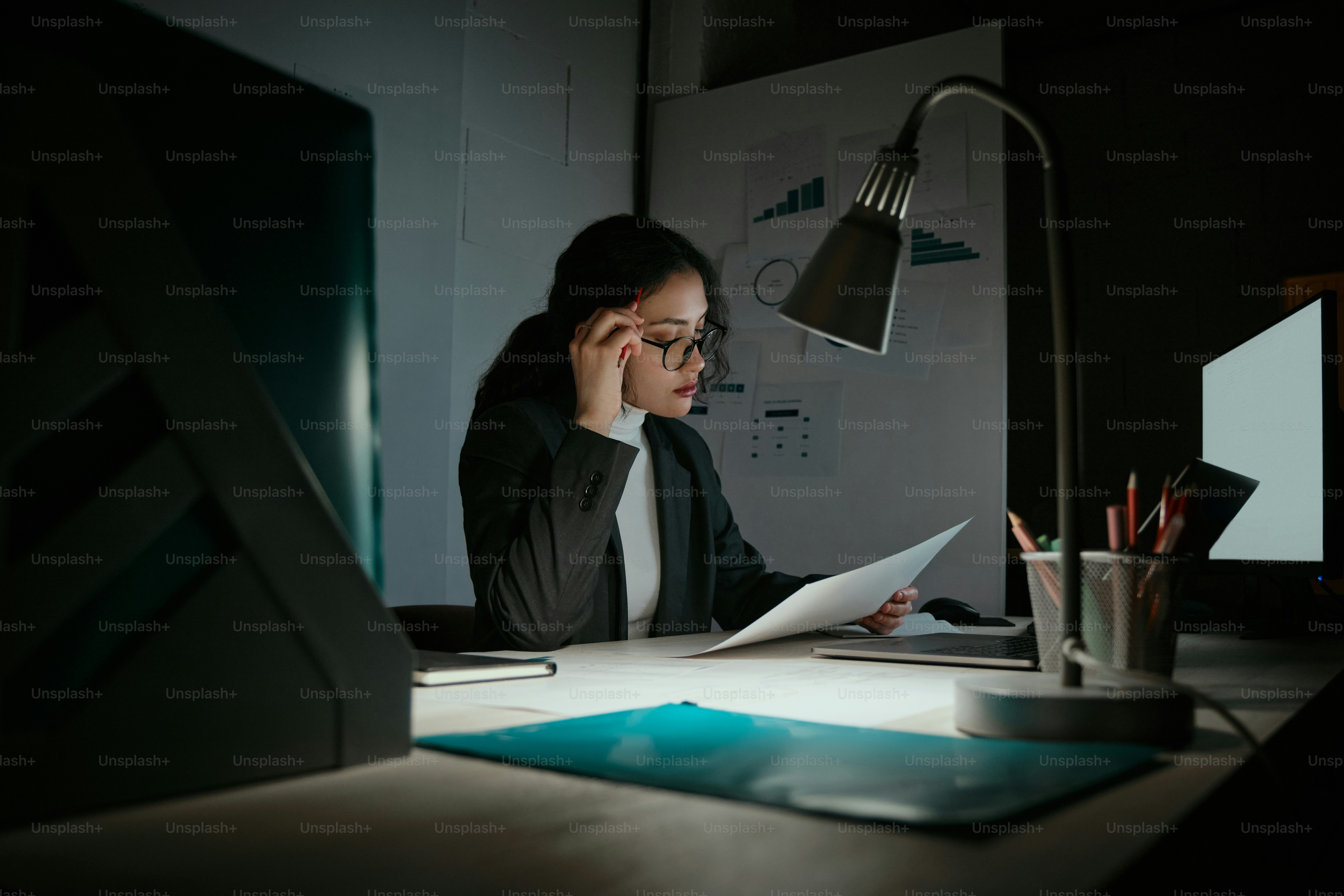 A woman sitting at a desk in front of a computer