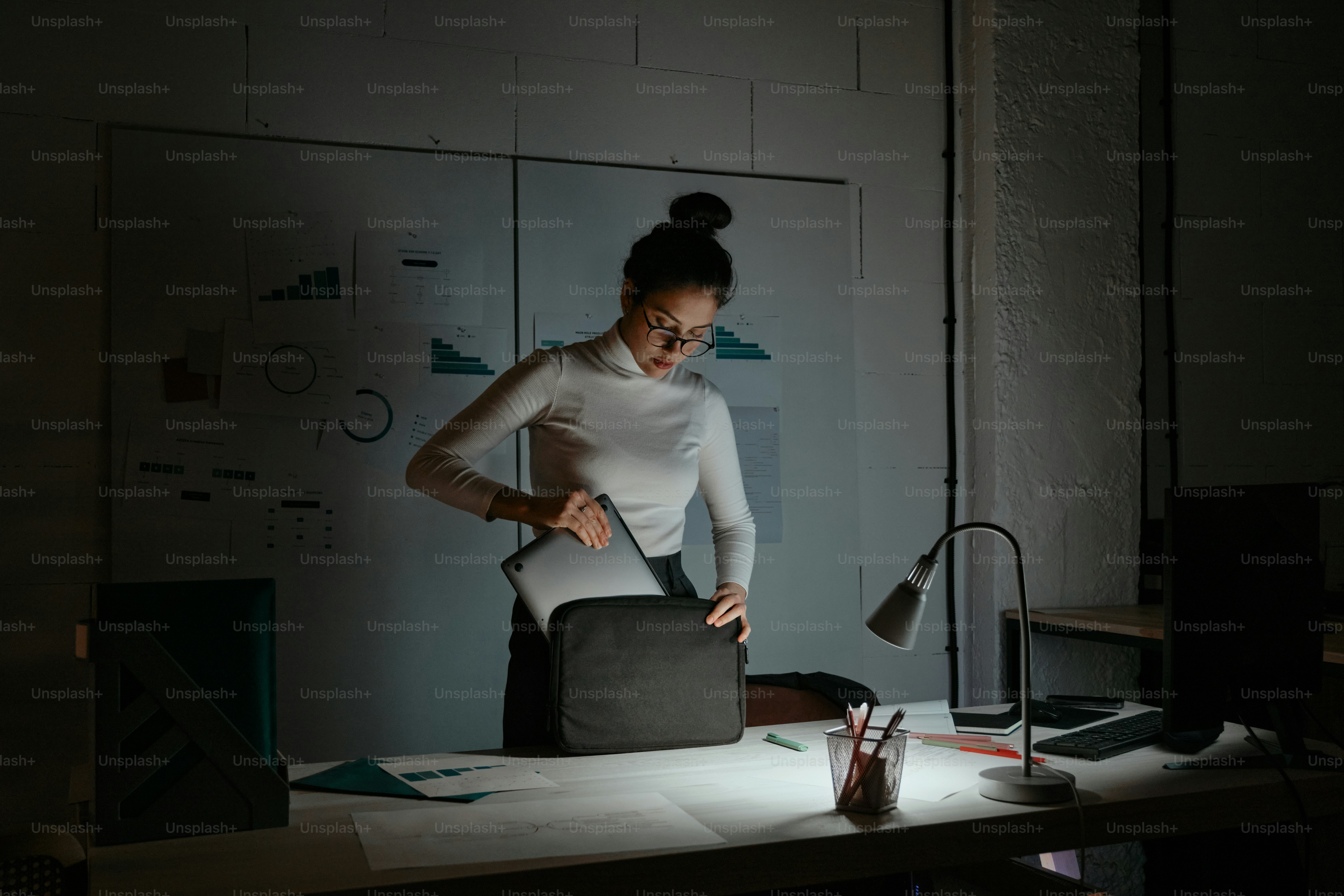 A woman standing in front of a mirror in a room