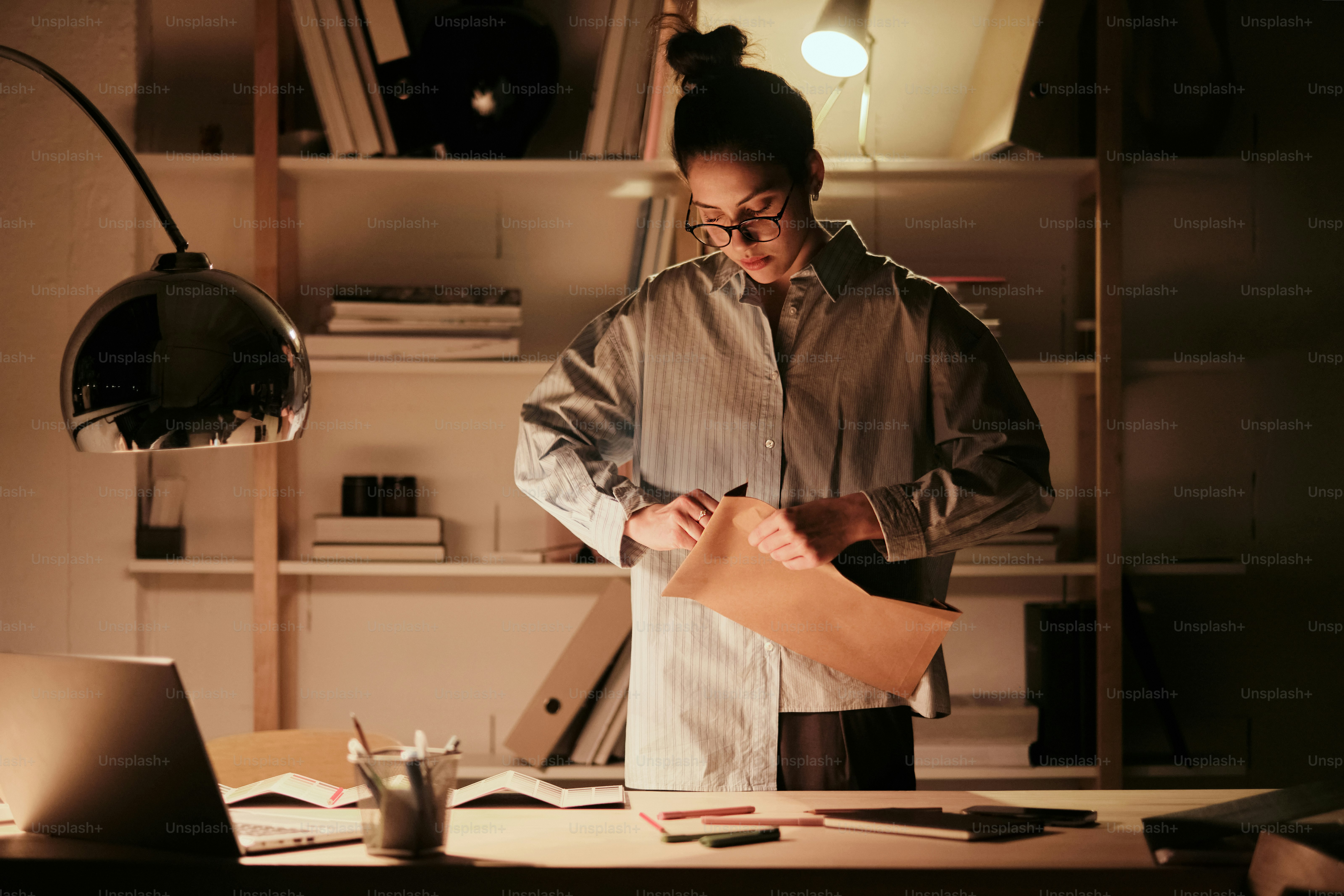 A man standing in front of a desk in an office