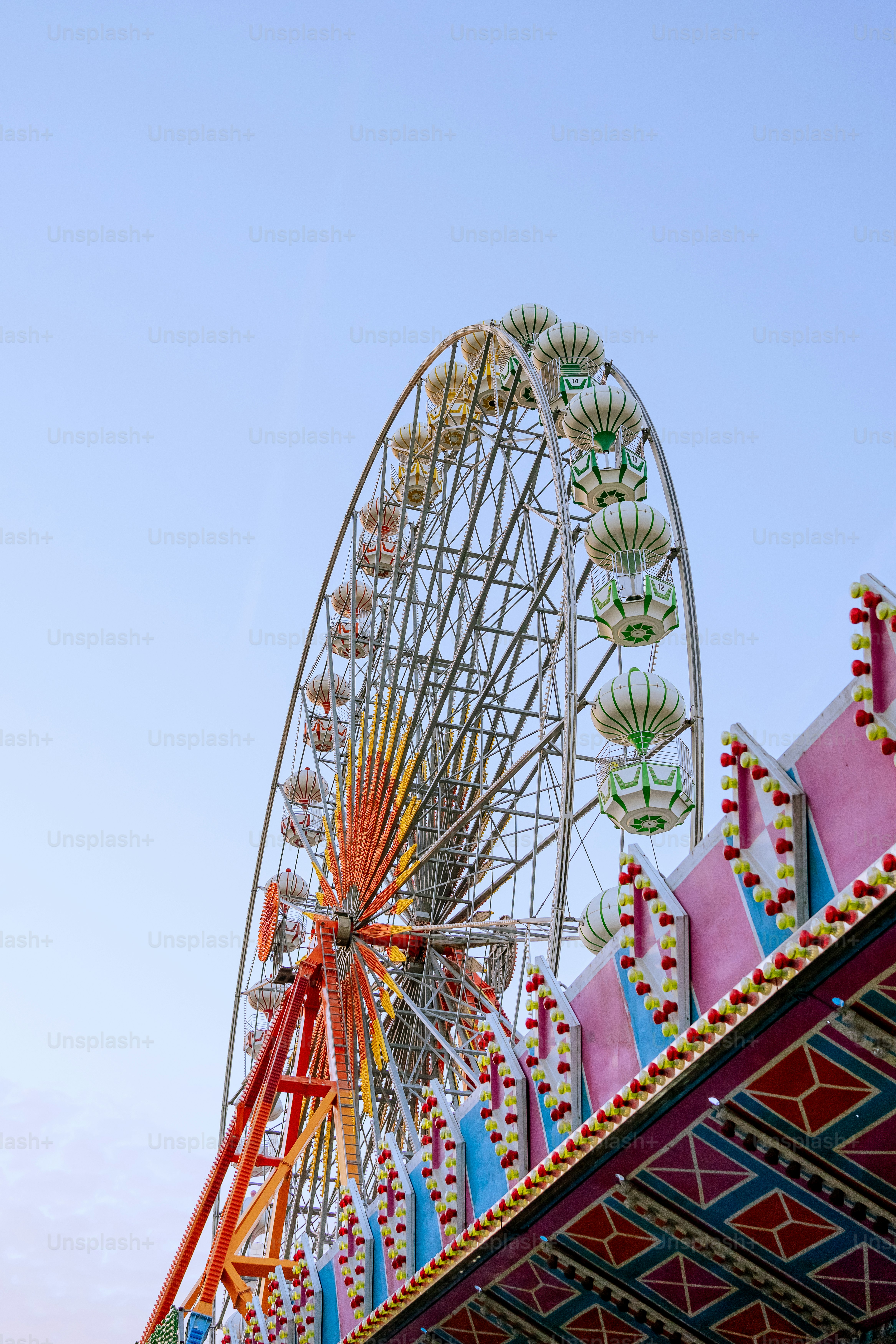 A carnival ride with a ferris wheel in the background