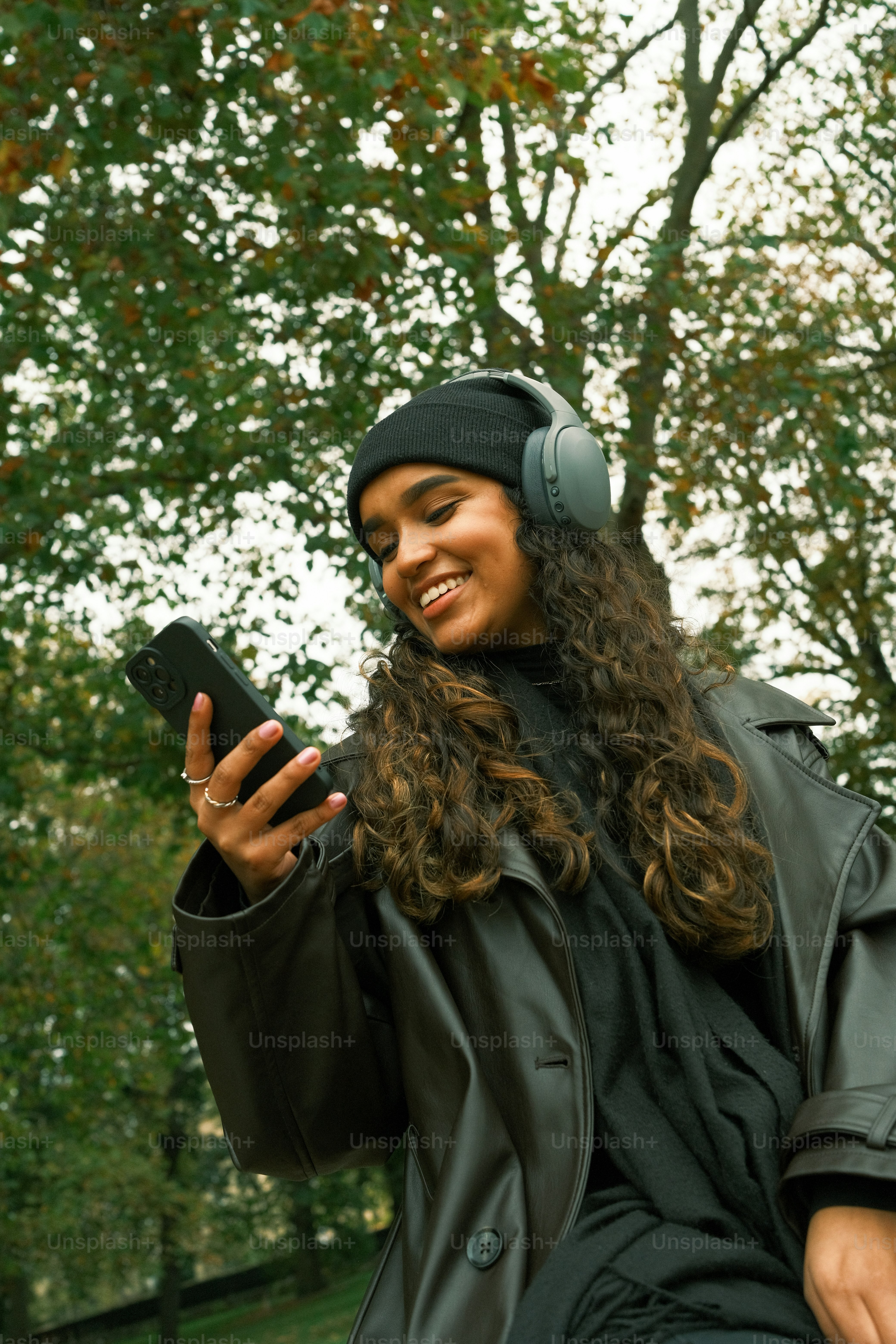 A woman sitting on a bench holding a cell phone