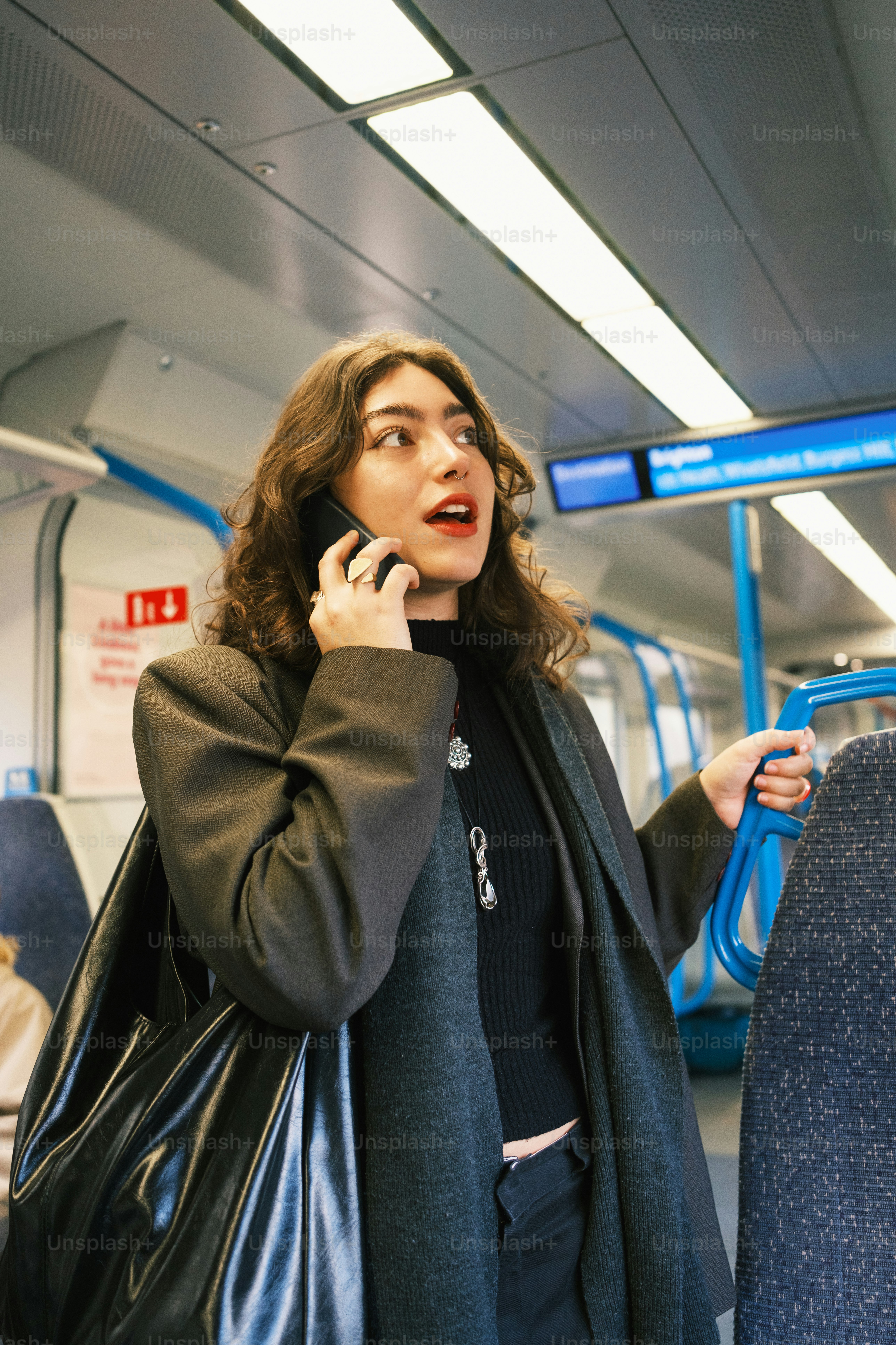 A woman talking on a cell phone on a train