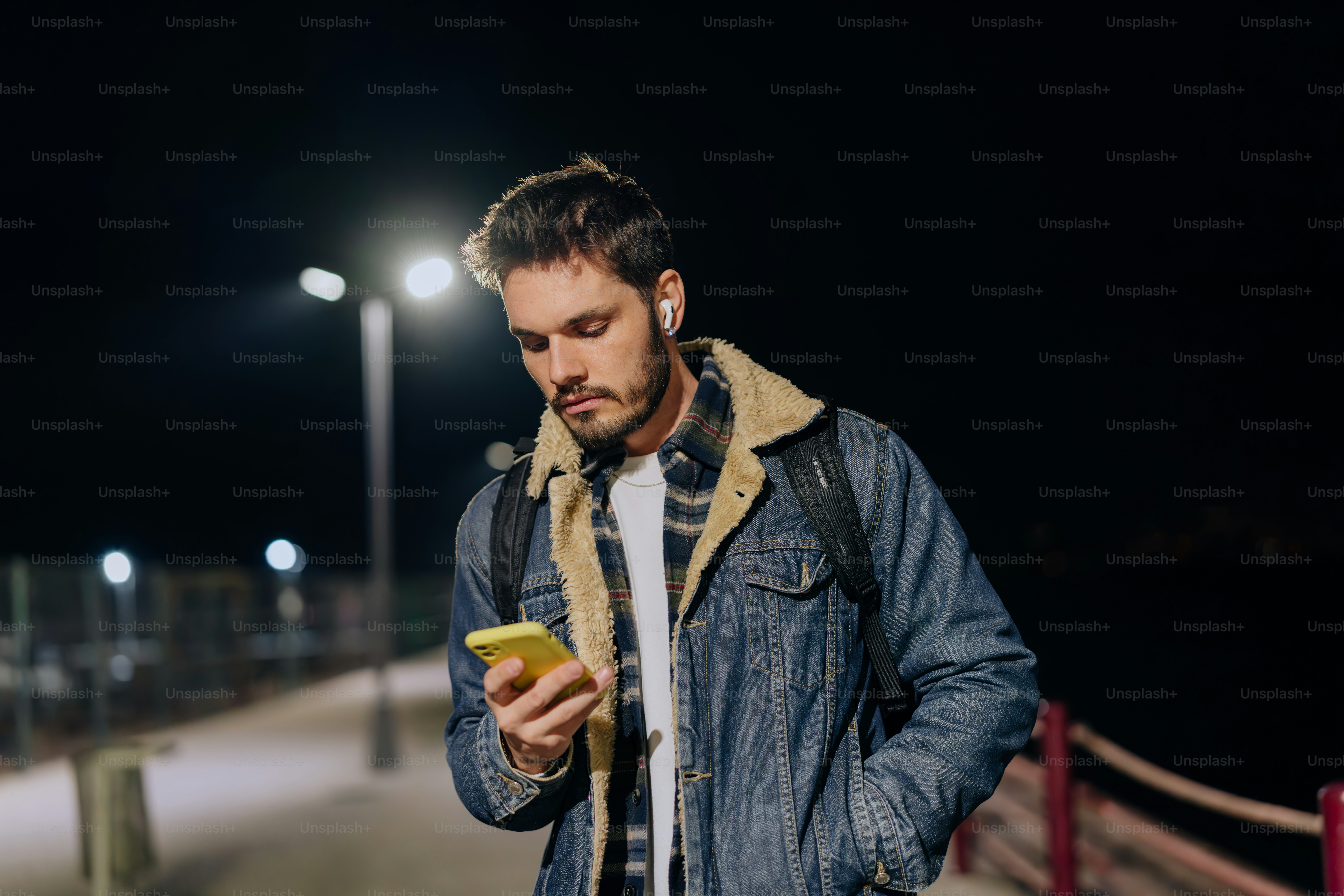A man laying in the grass talking on a cell phone photo – Music Image ...