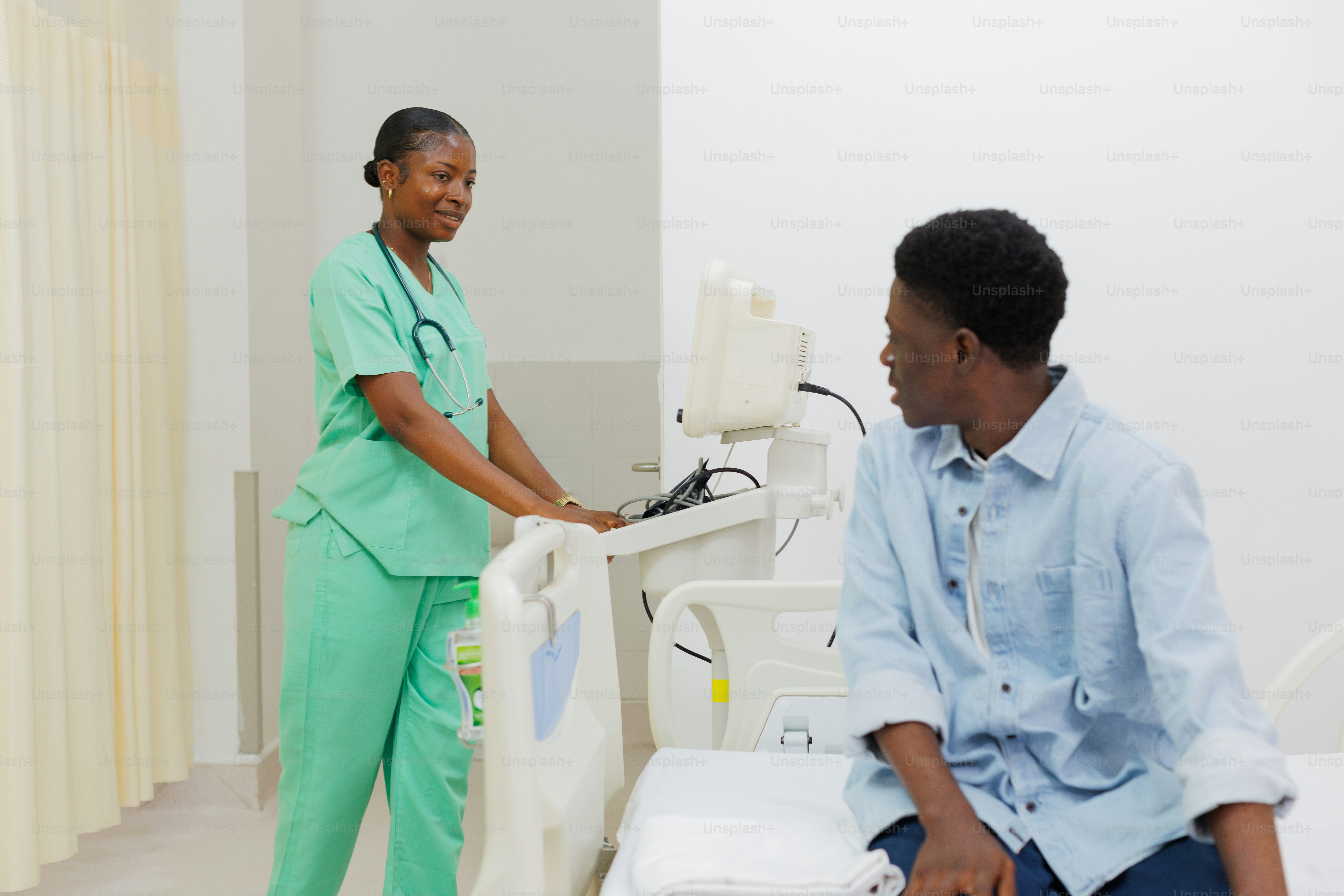 A nurse caring for a patient in an exam room