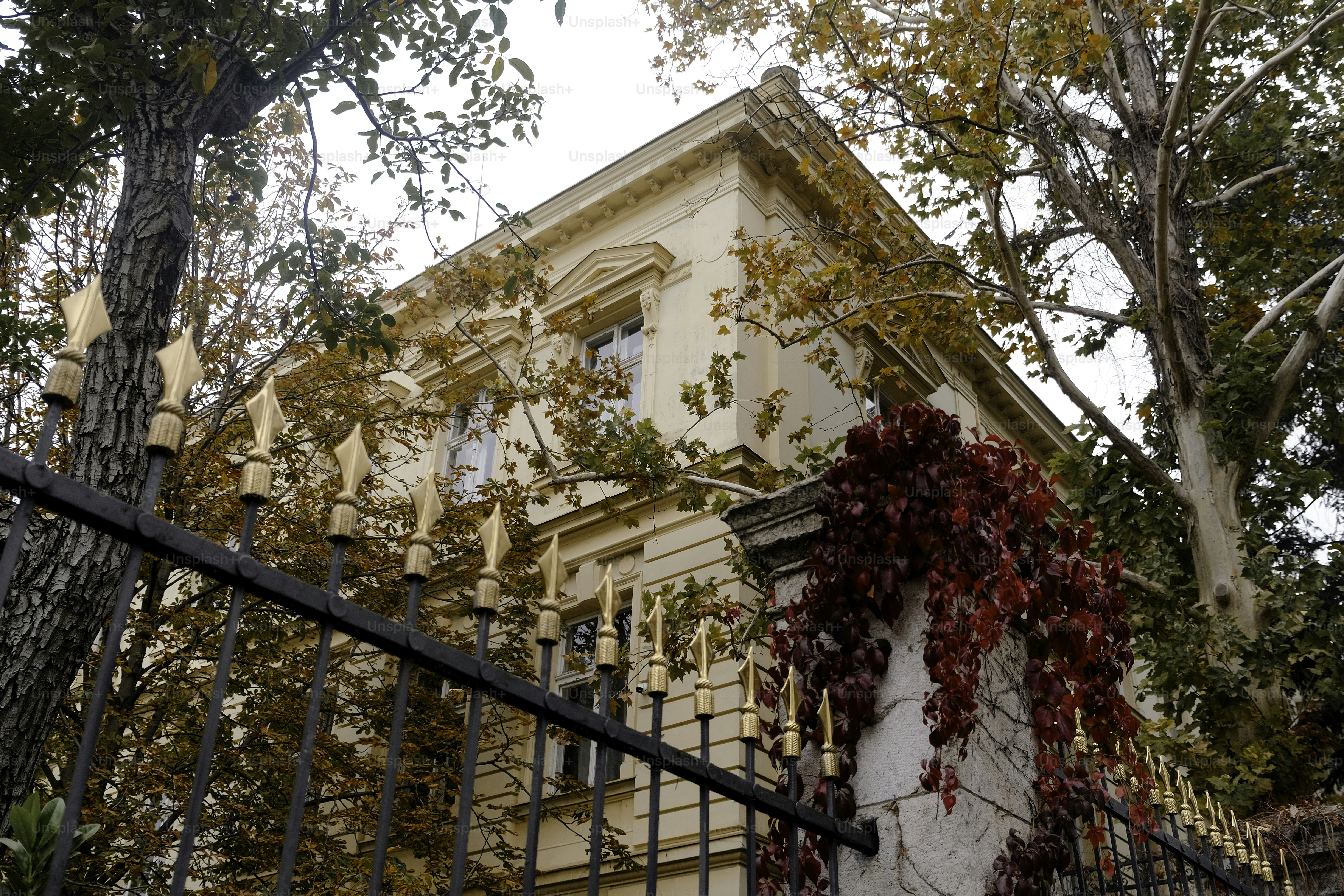 A tall building with a wrought iron fence in front of it