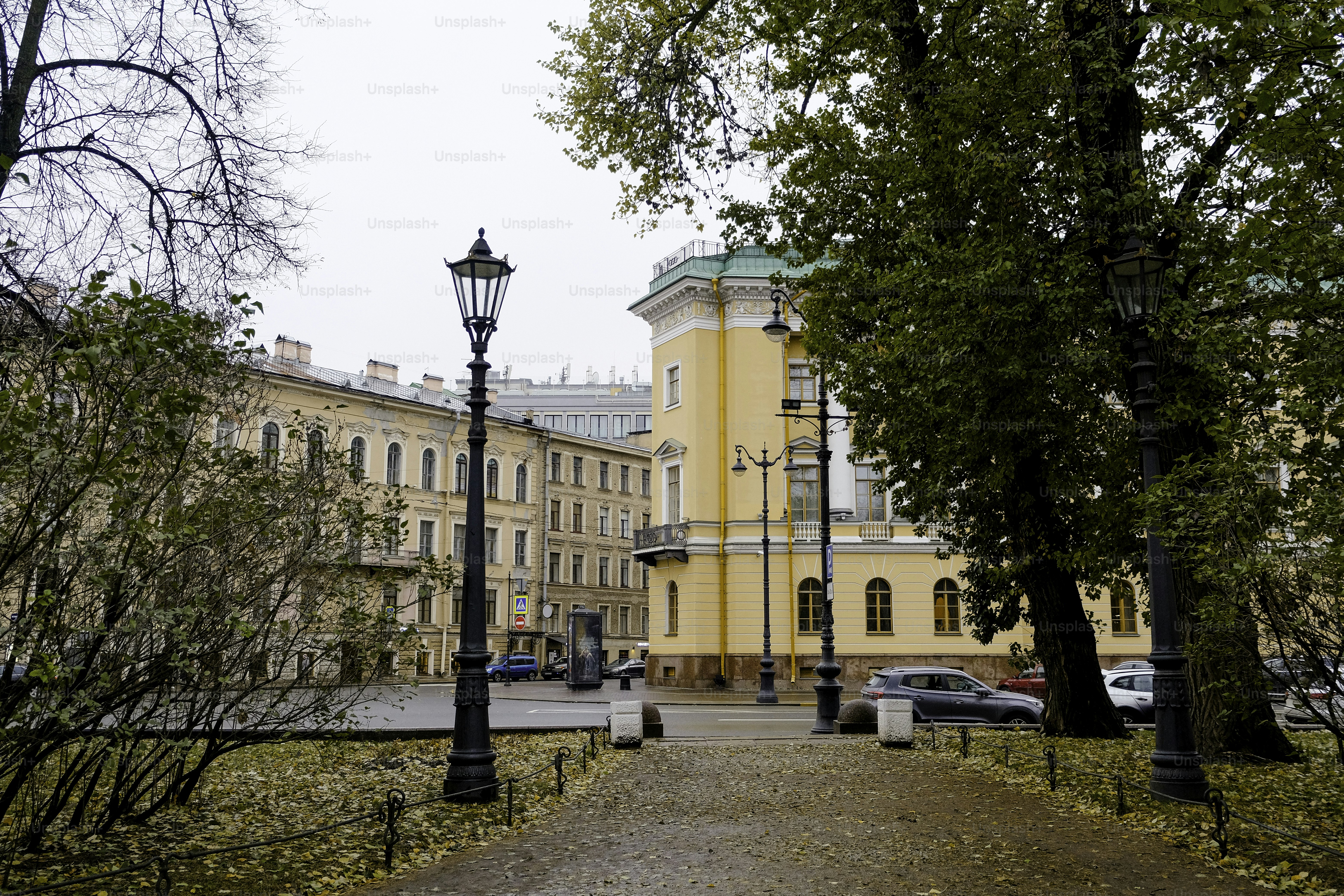 A yellow building with a street light in front of it