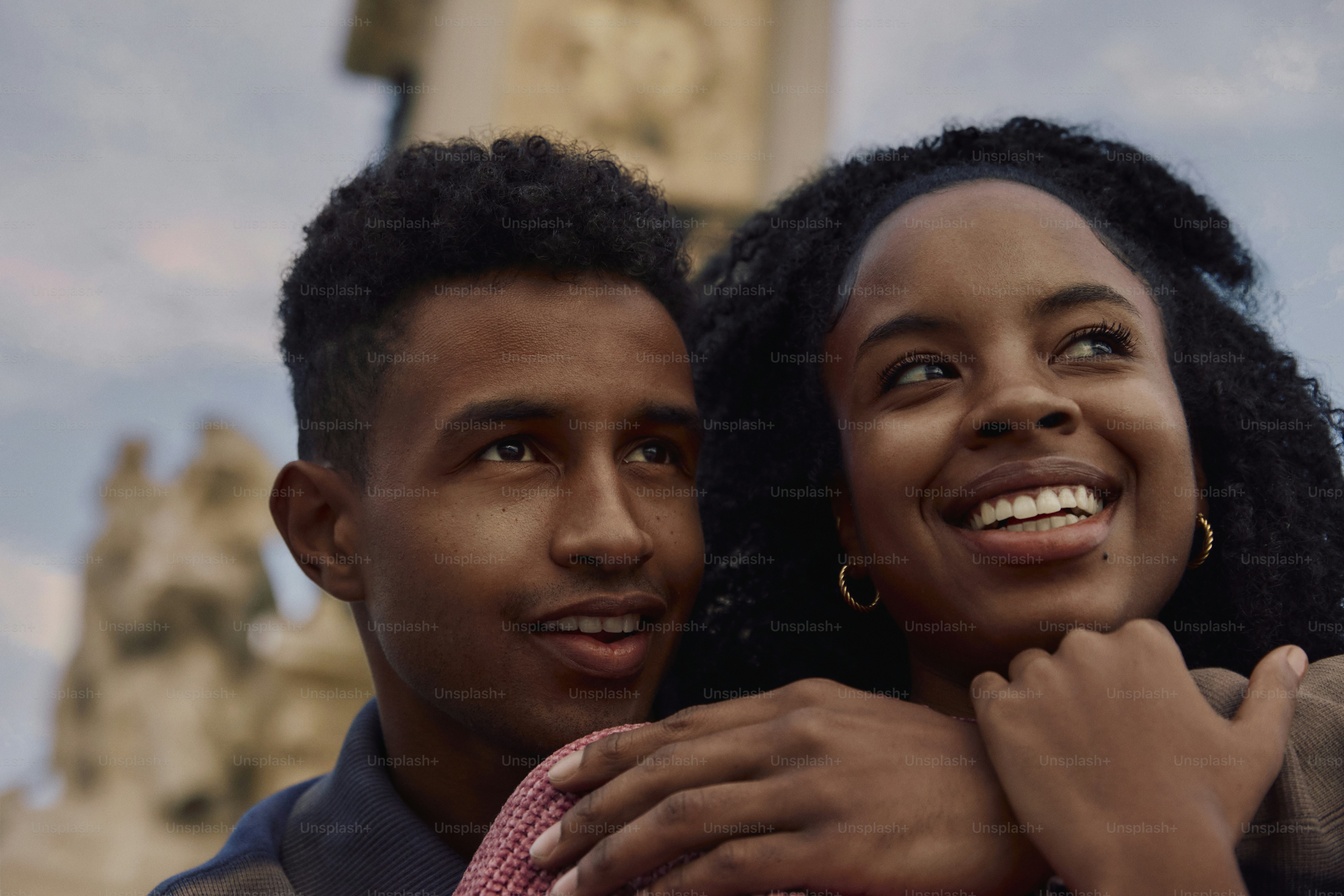 A man and a woman standing together in front of a clock tower photo ...