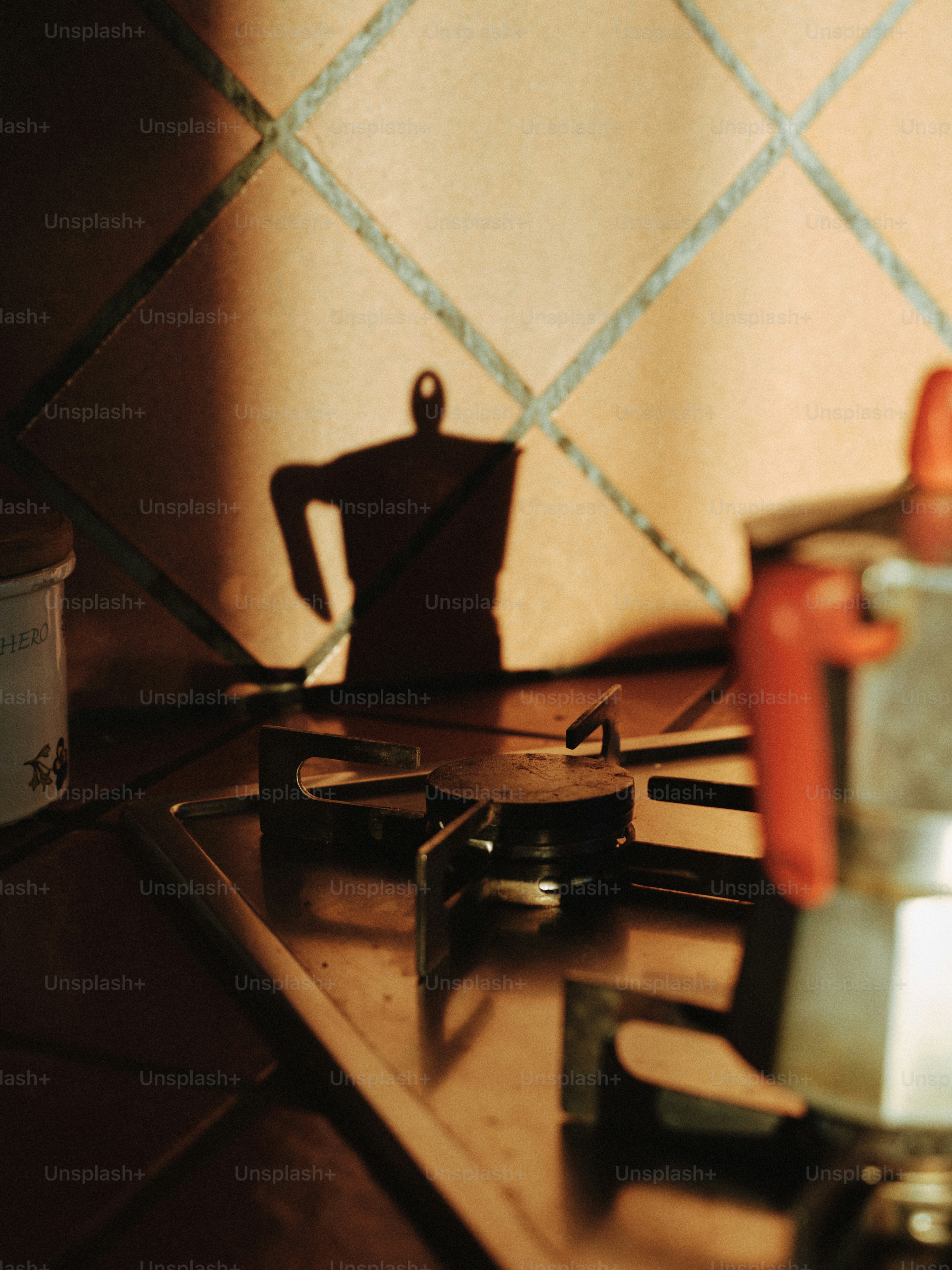 A stove top with a blender on top of it