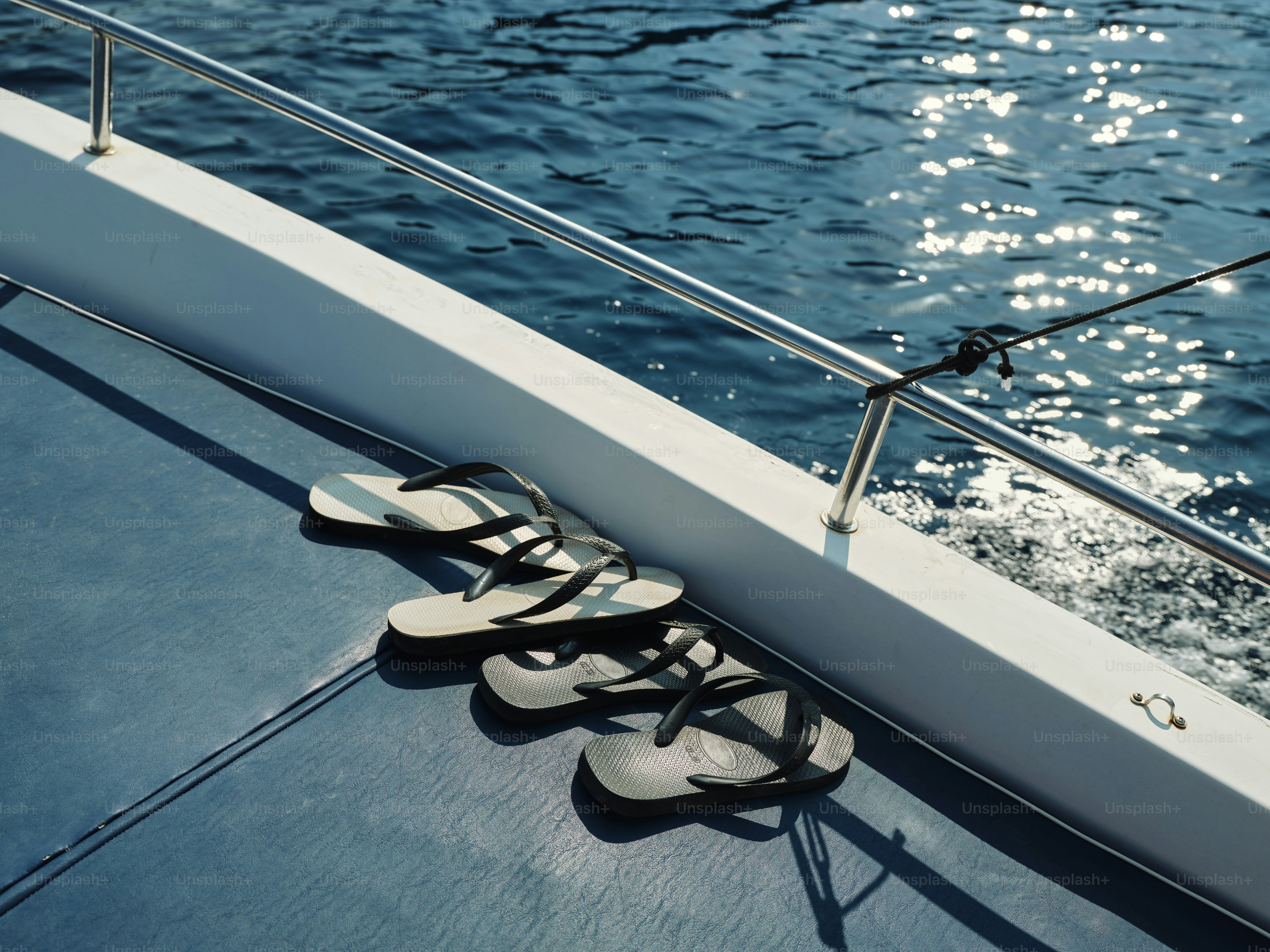 A pair of shoes sitting on the edge of a boat