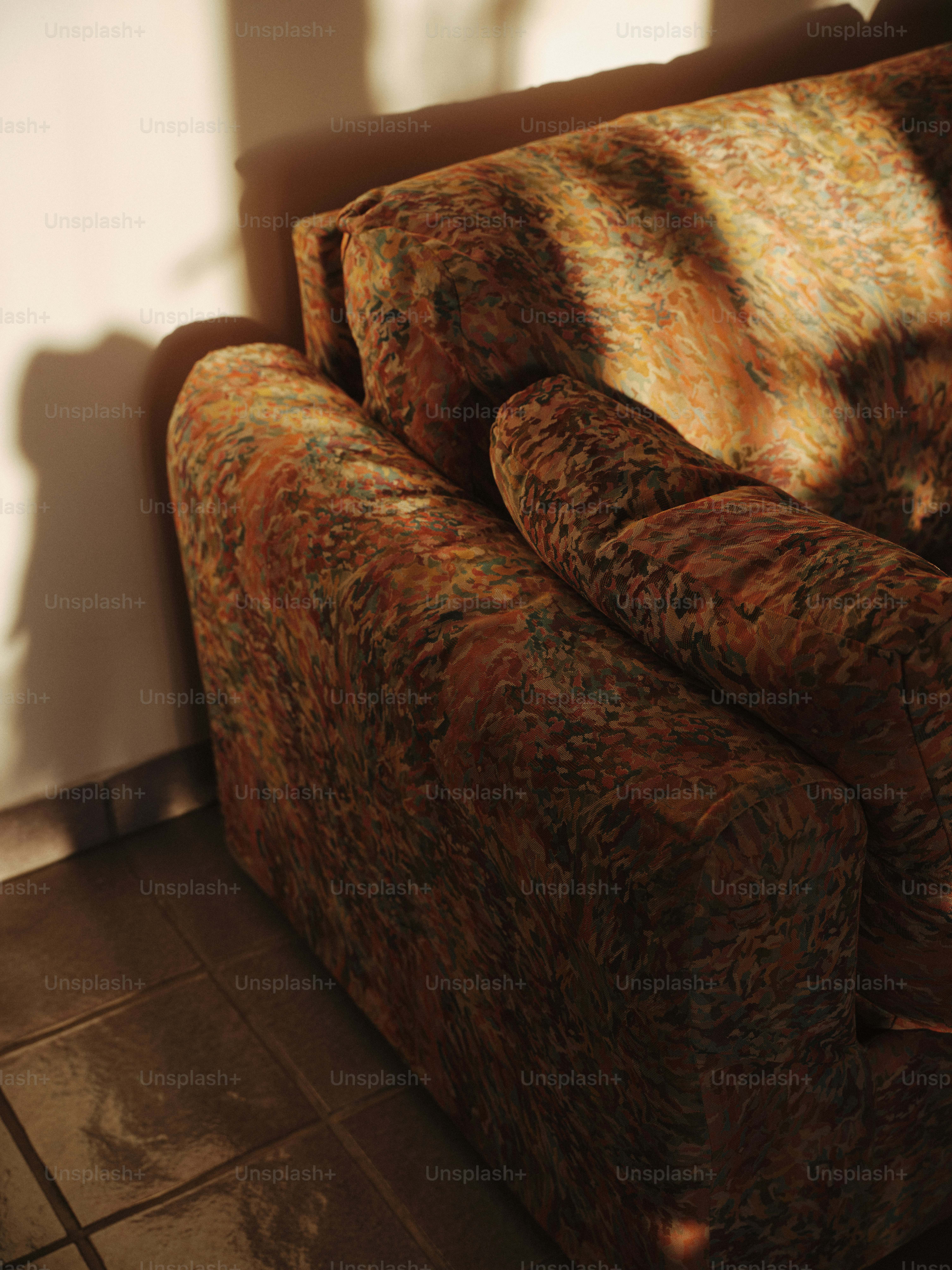 A brown couch sitting in a living room next to a window