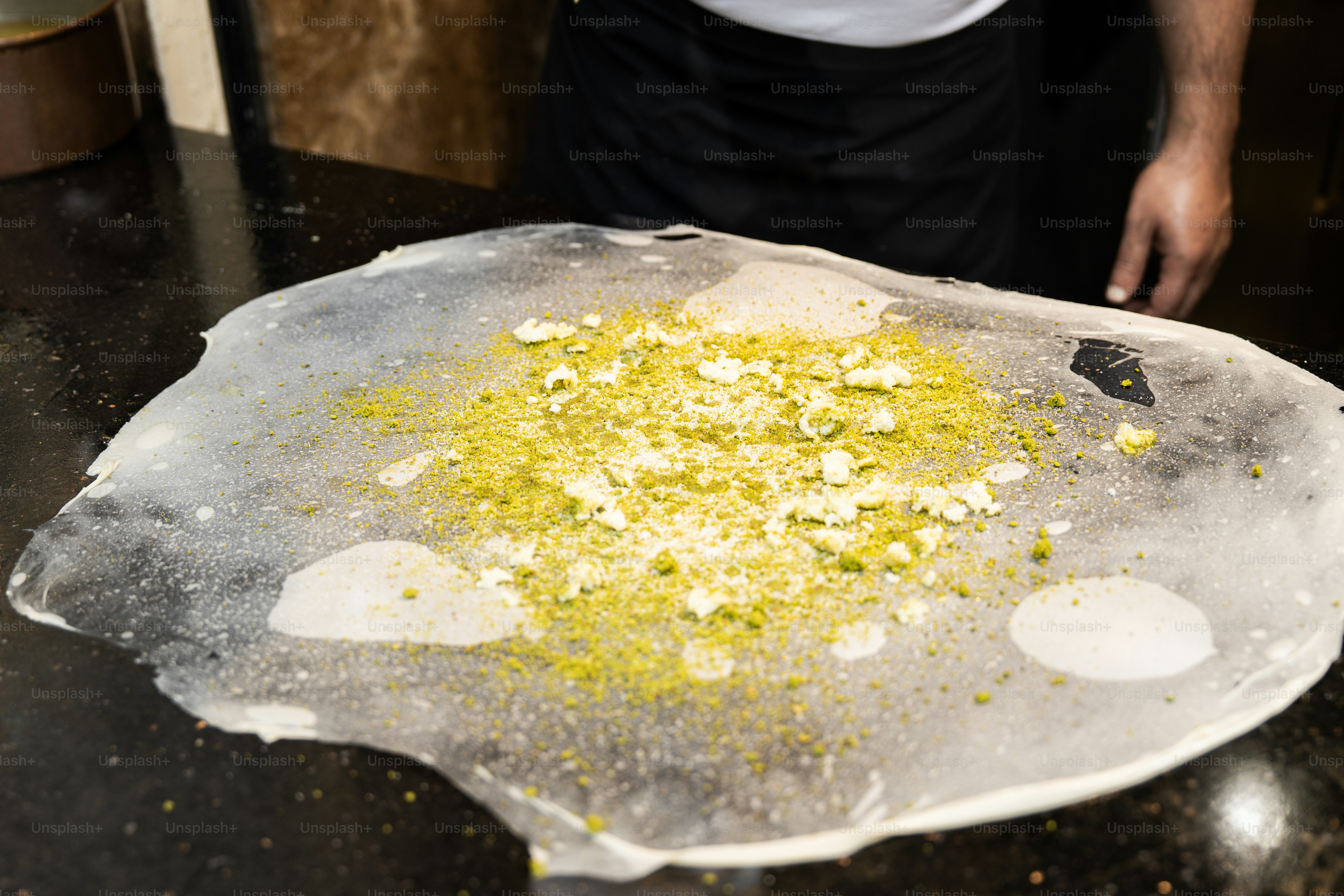 A man standing in front of a pan filled with food