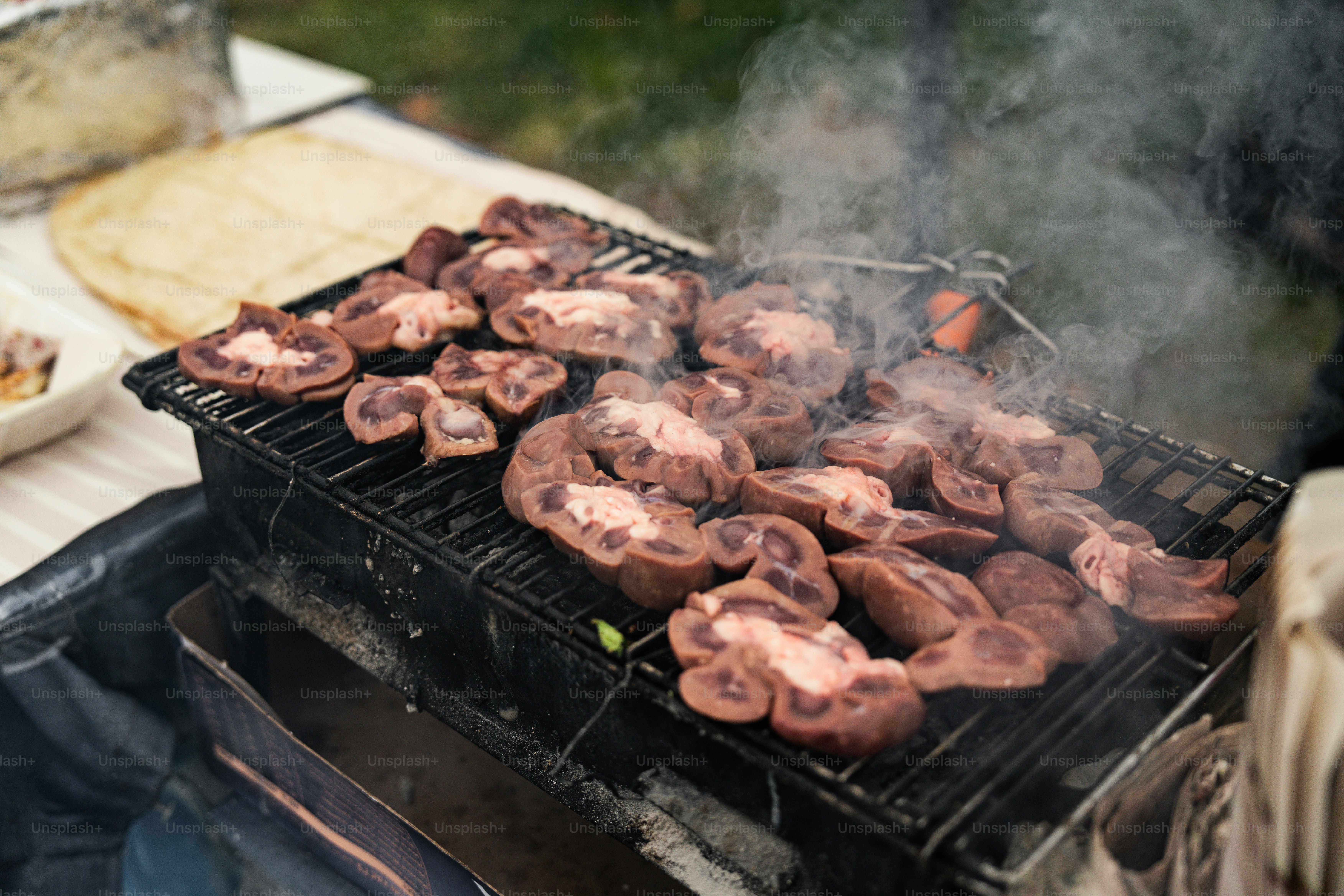 A person cooking food on top of a grill