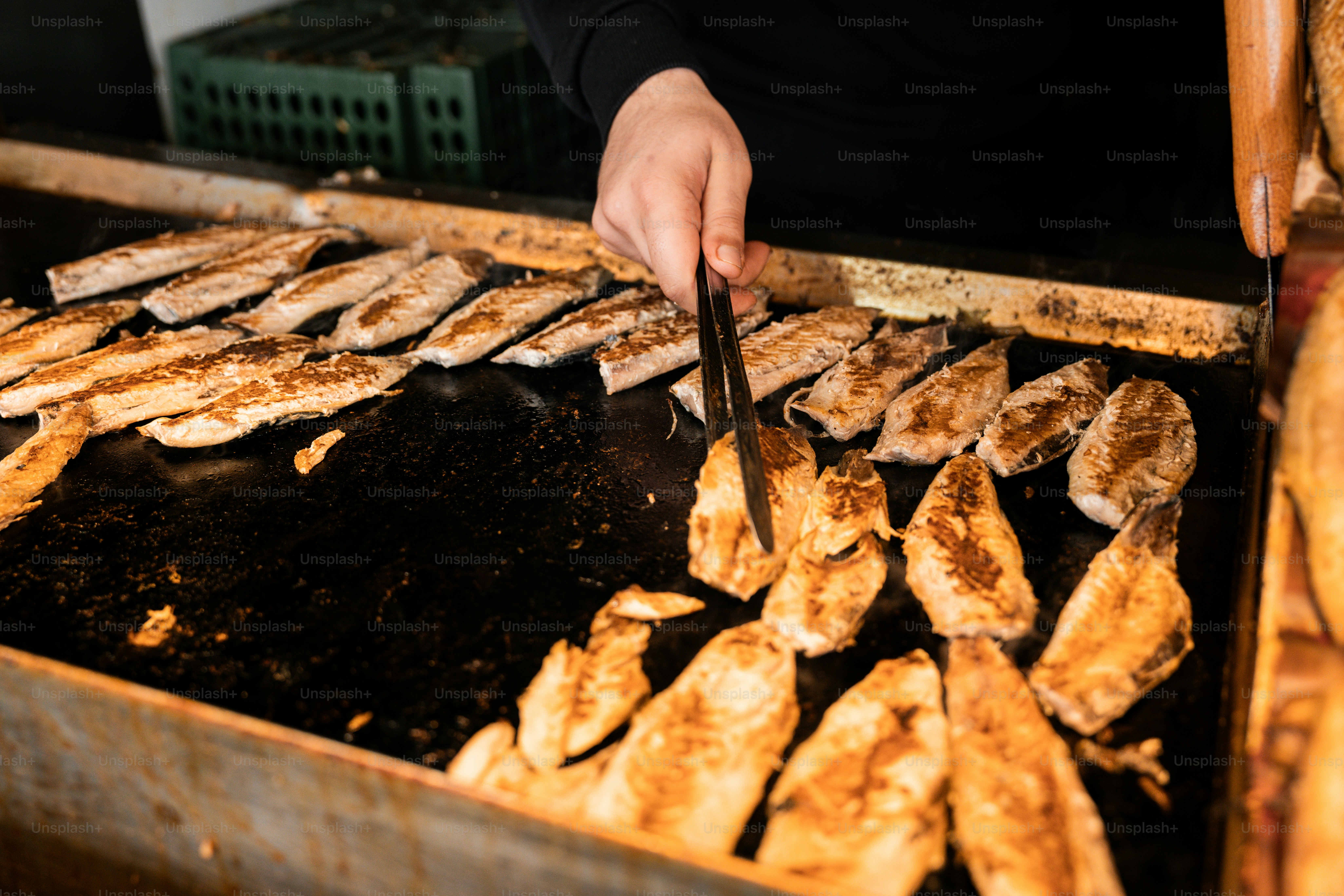 A person is cooking food on a grill