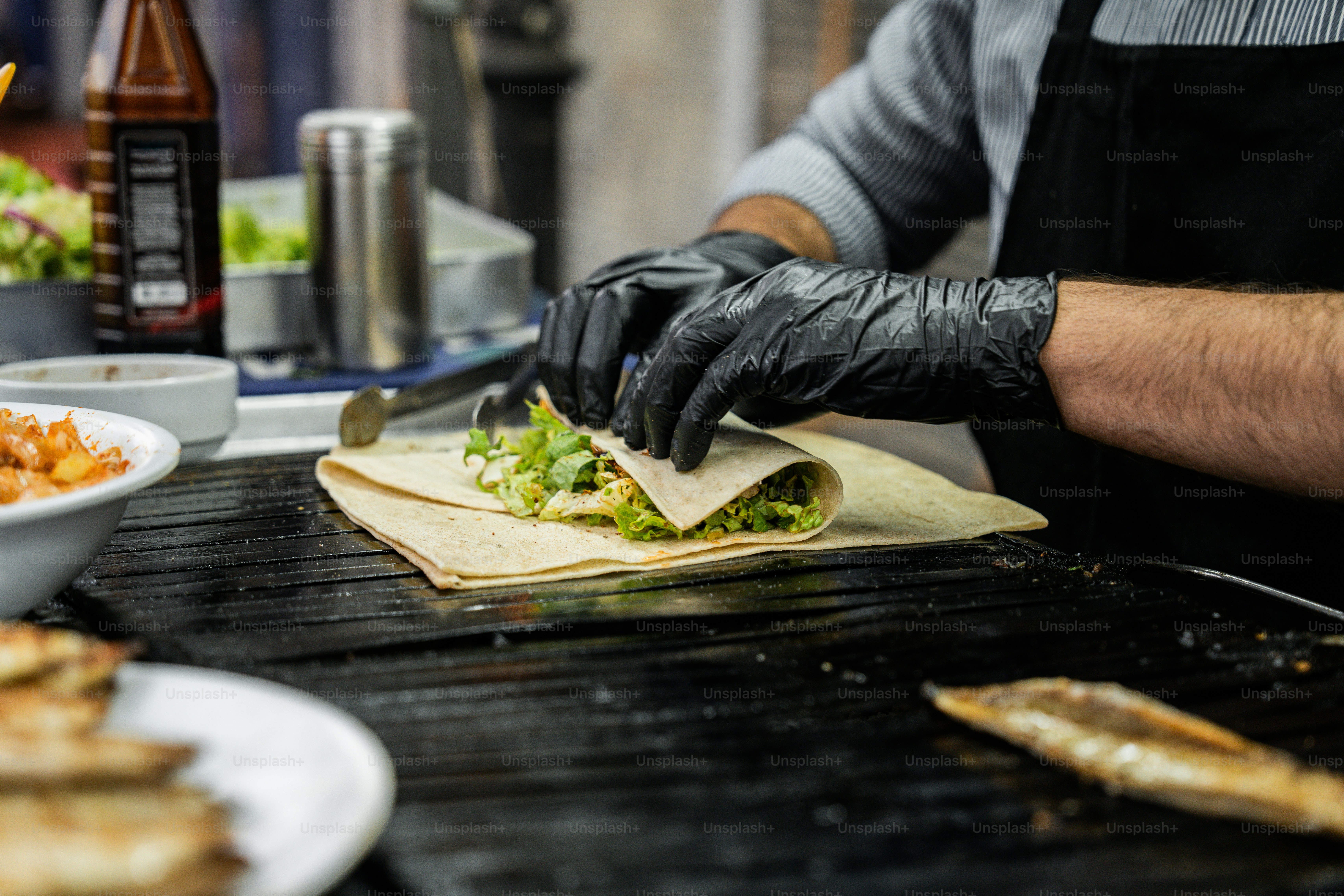 A man preparing food on top of a grill