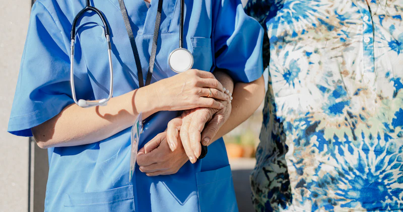 Skilled nurse holding hands with client