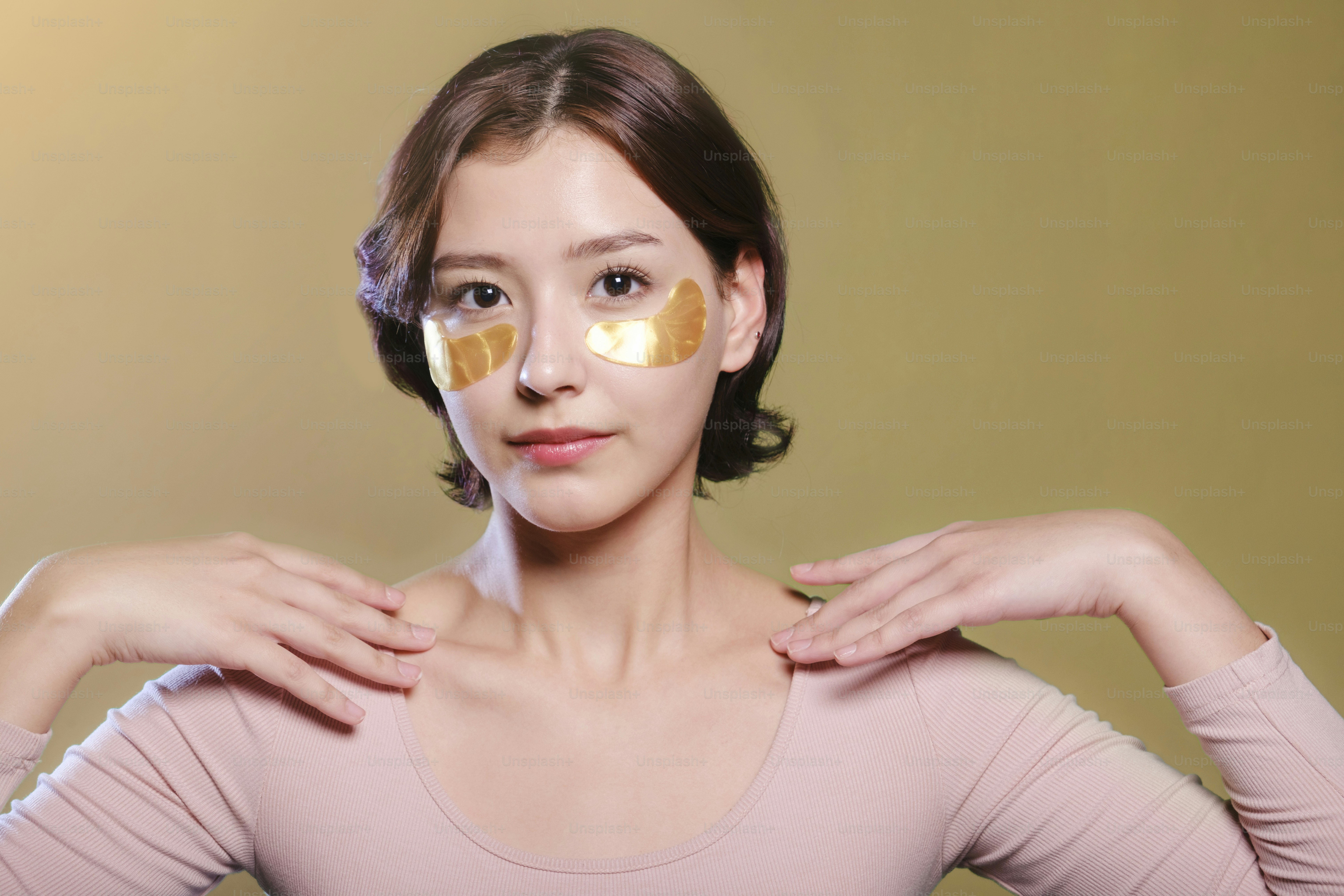 A woman with a sheet of gold on her face