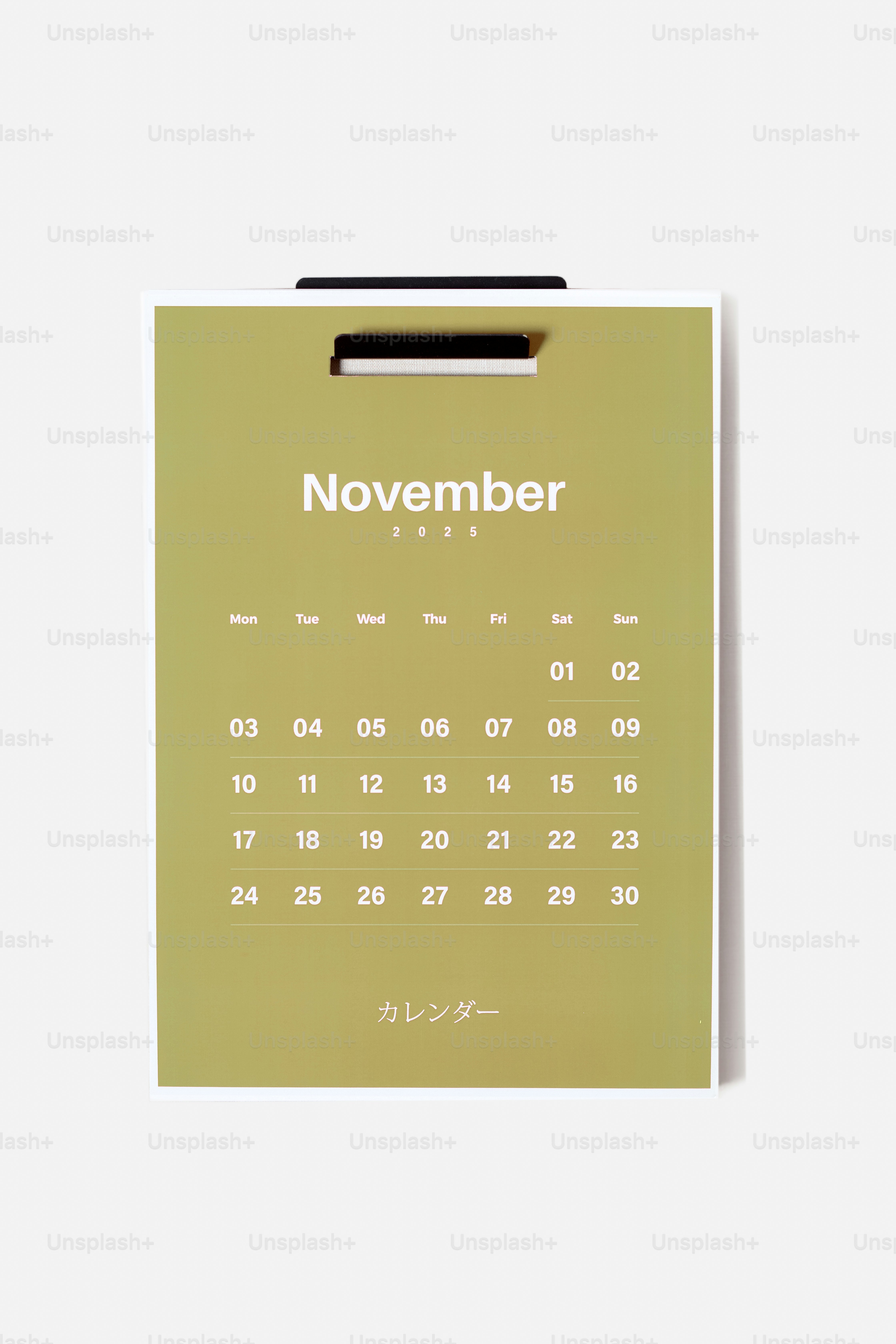 A calendar with a pen on top of it