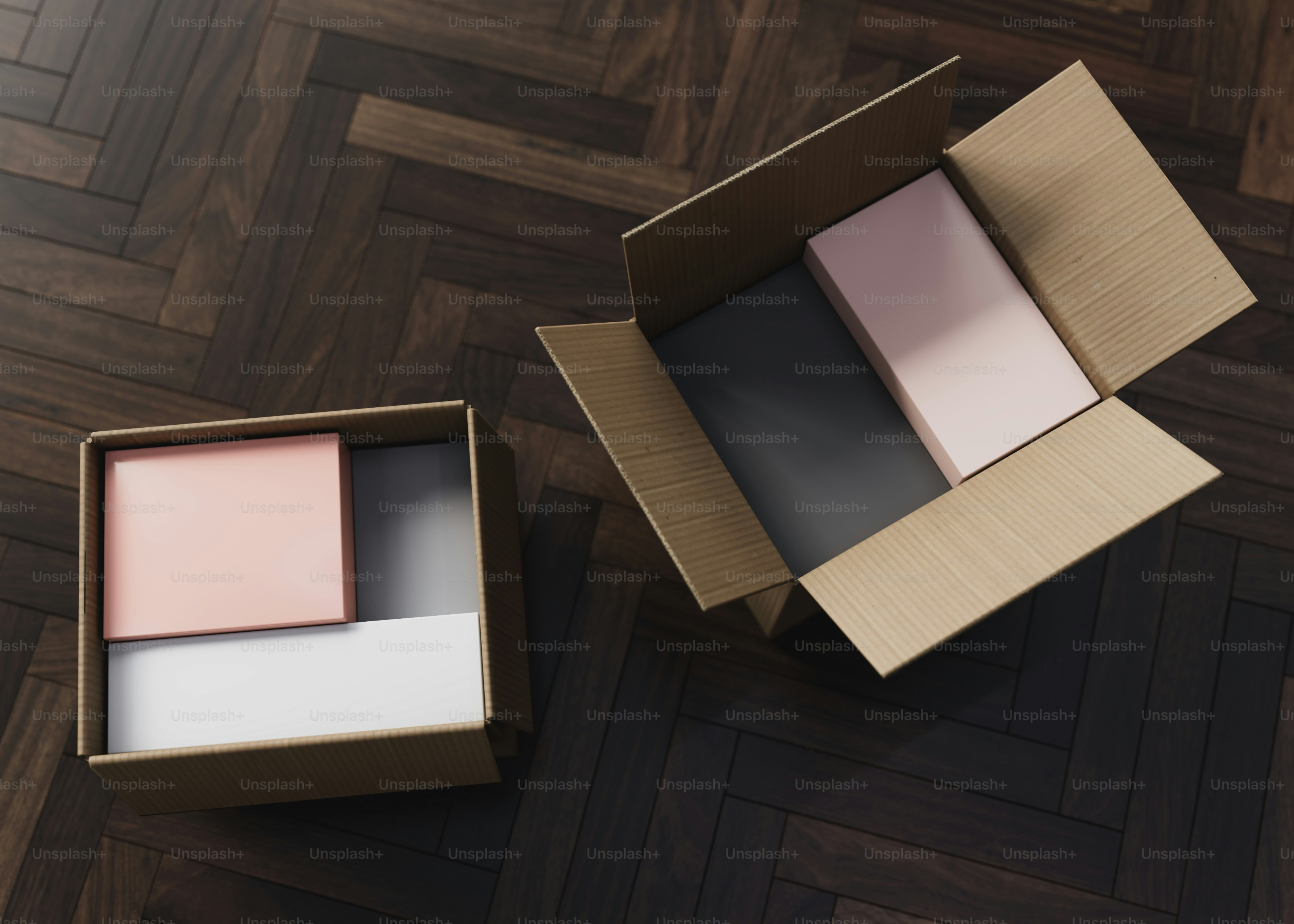Two open boxes sitting on top of a wooden floor