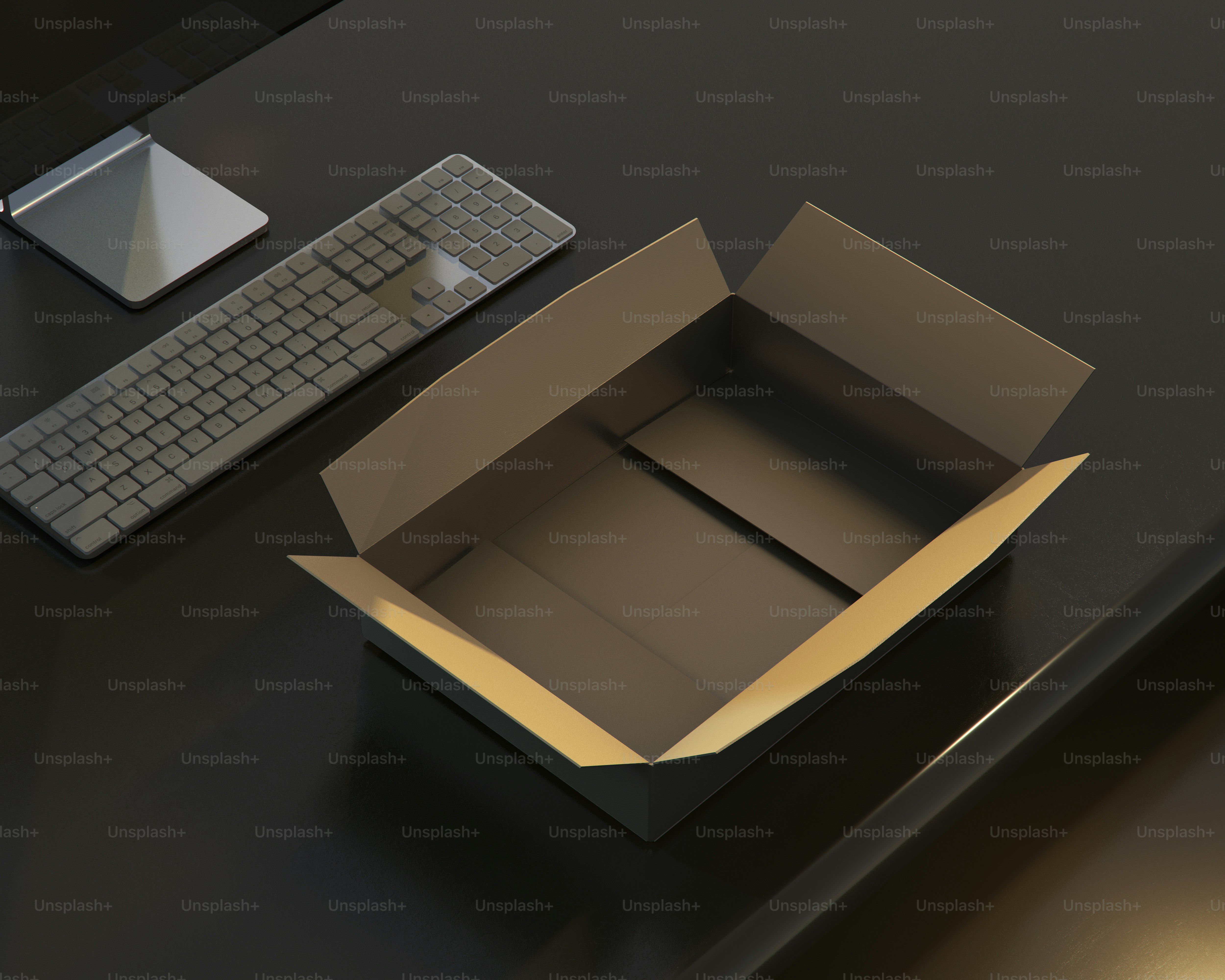 An open box sitting on top of a desk next to a keyboard