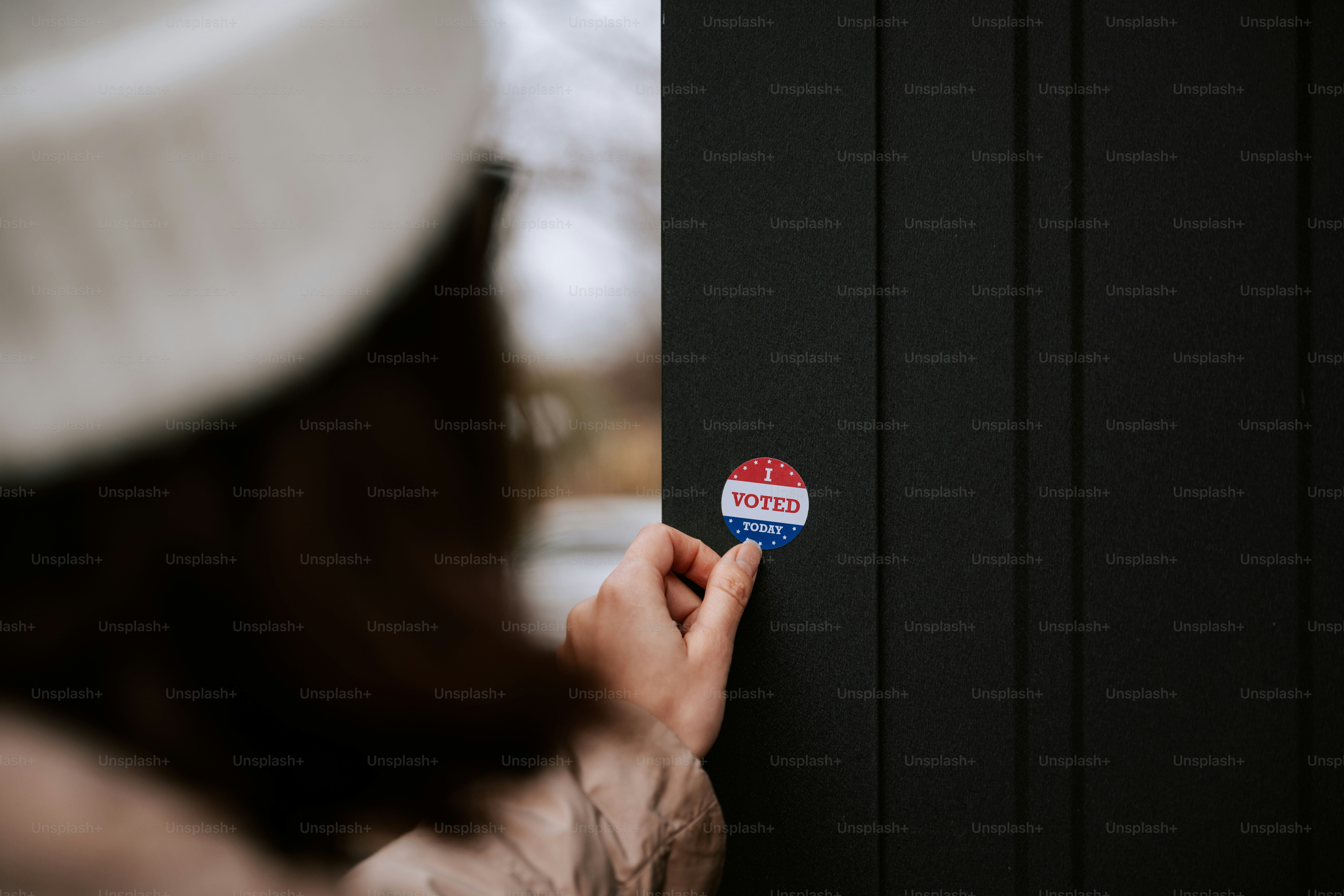 A person holding a button on a door