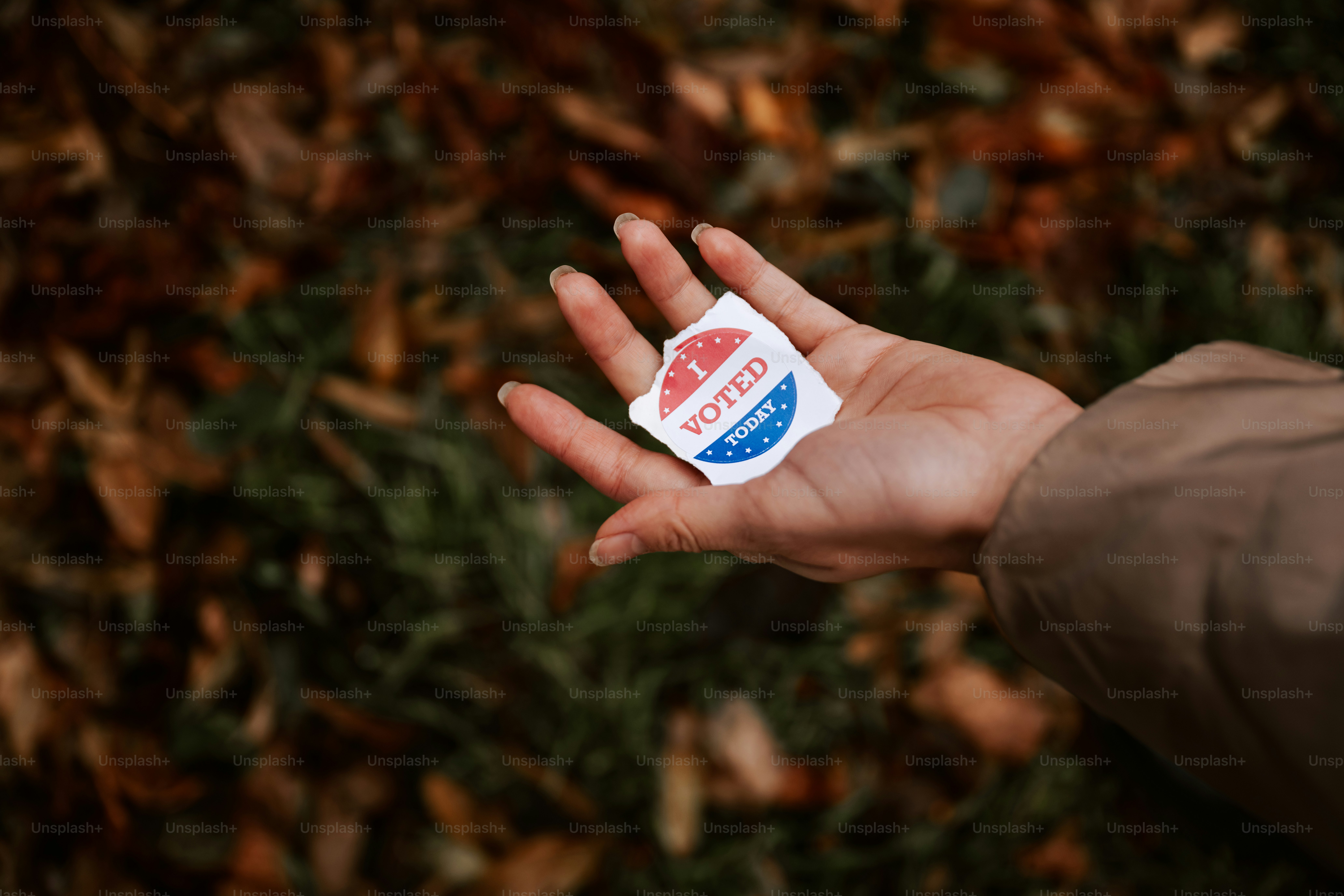 A person holding out their hand with a sticker on it
