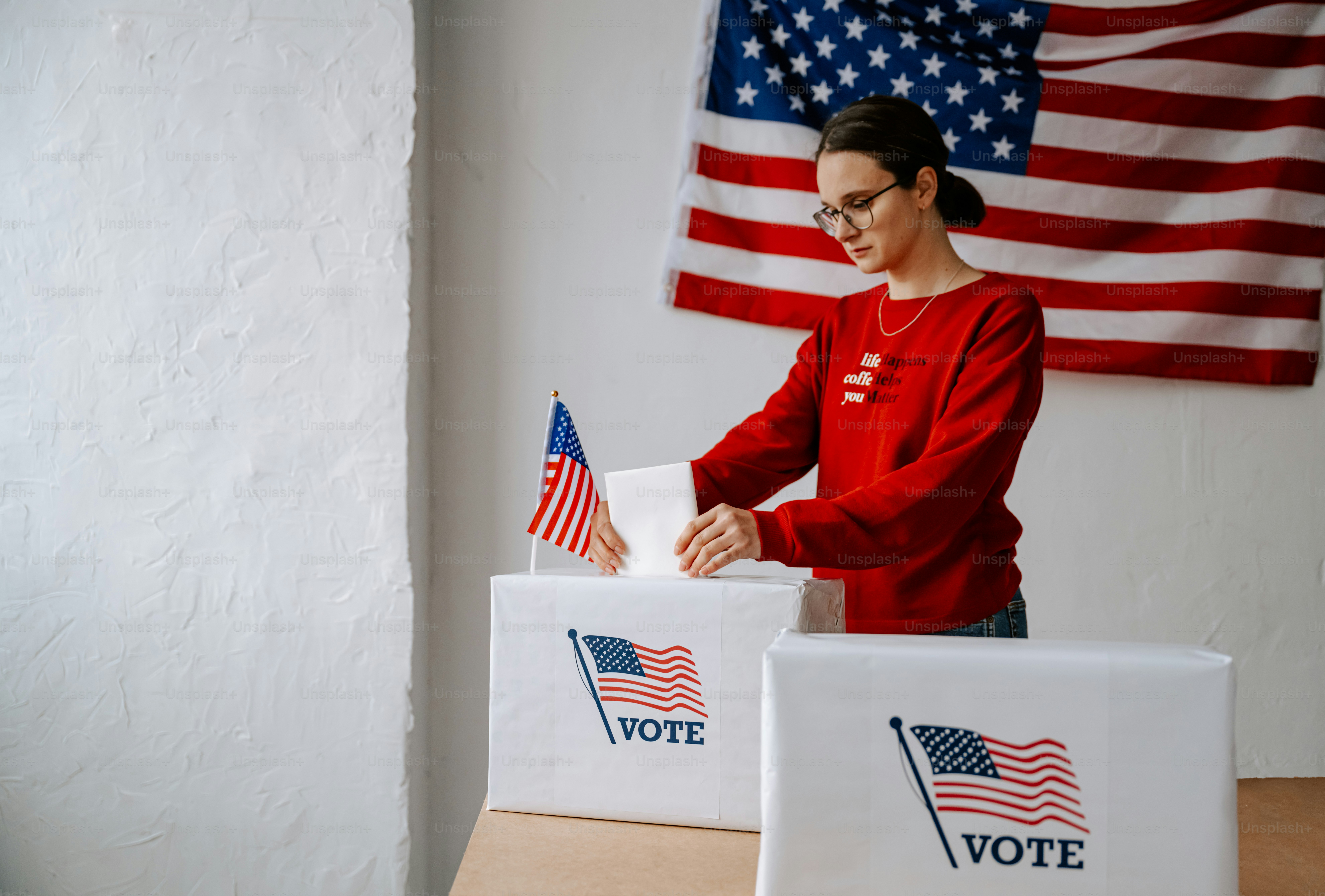 A woman casts a voting paper in a voting box