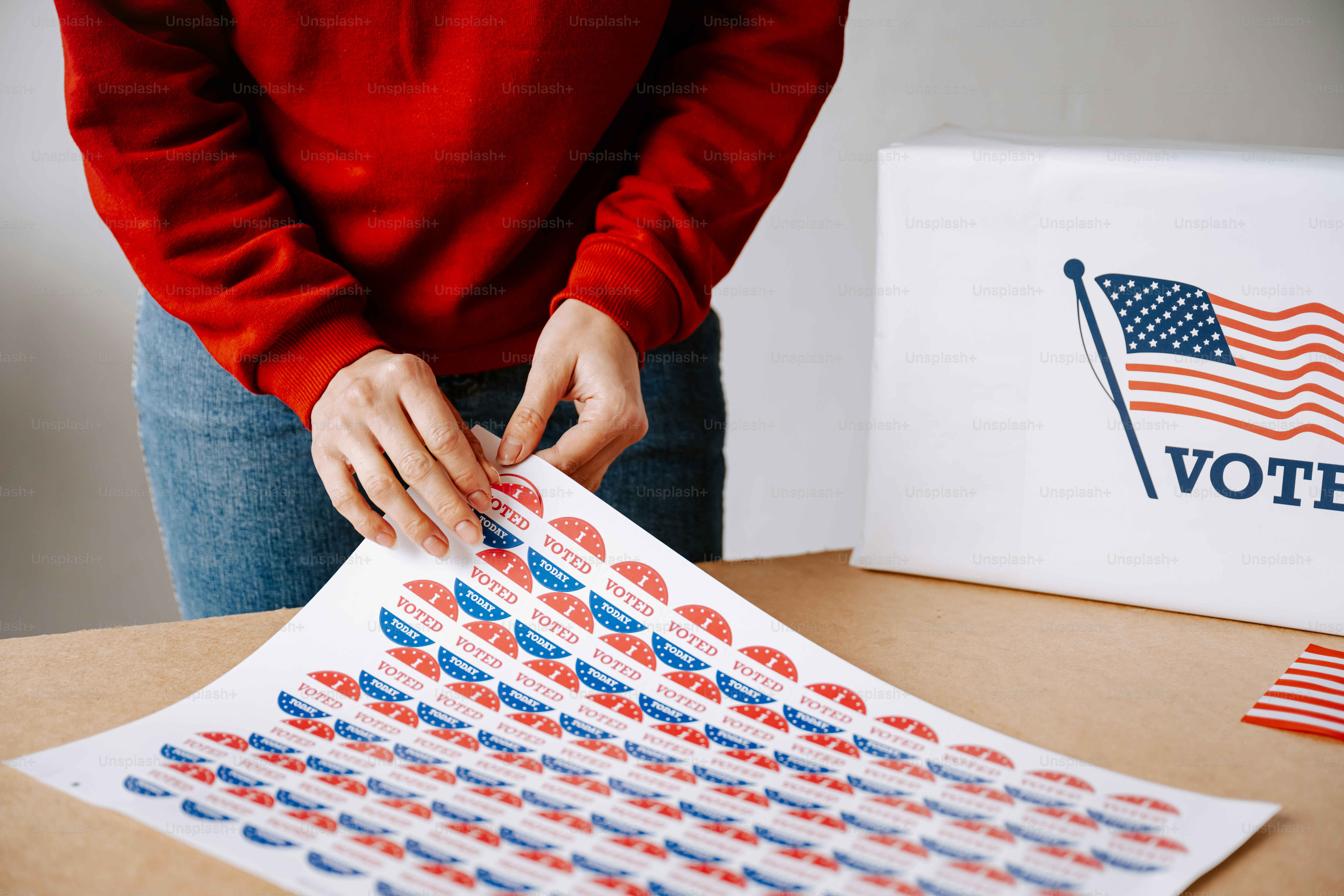 A person putting a voting paper in a voting box photo – Blue Image on ...