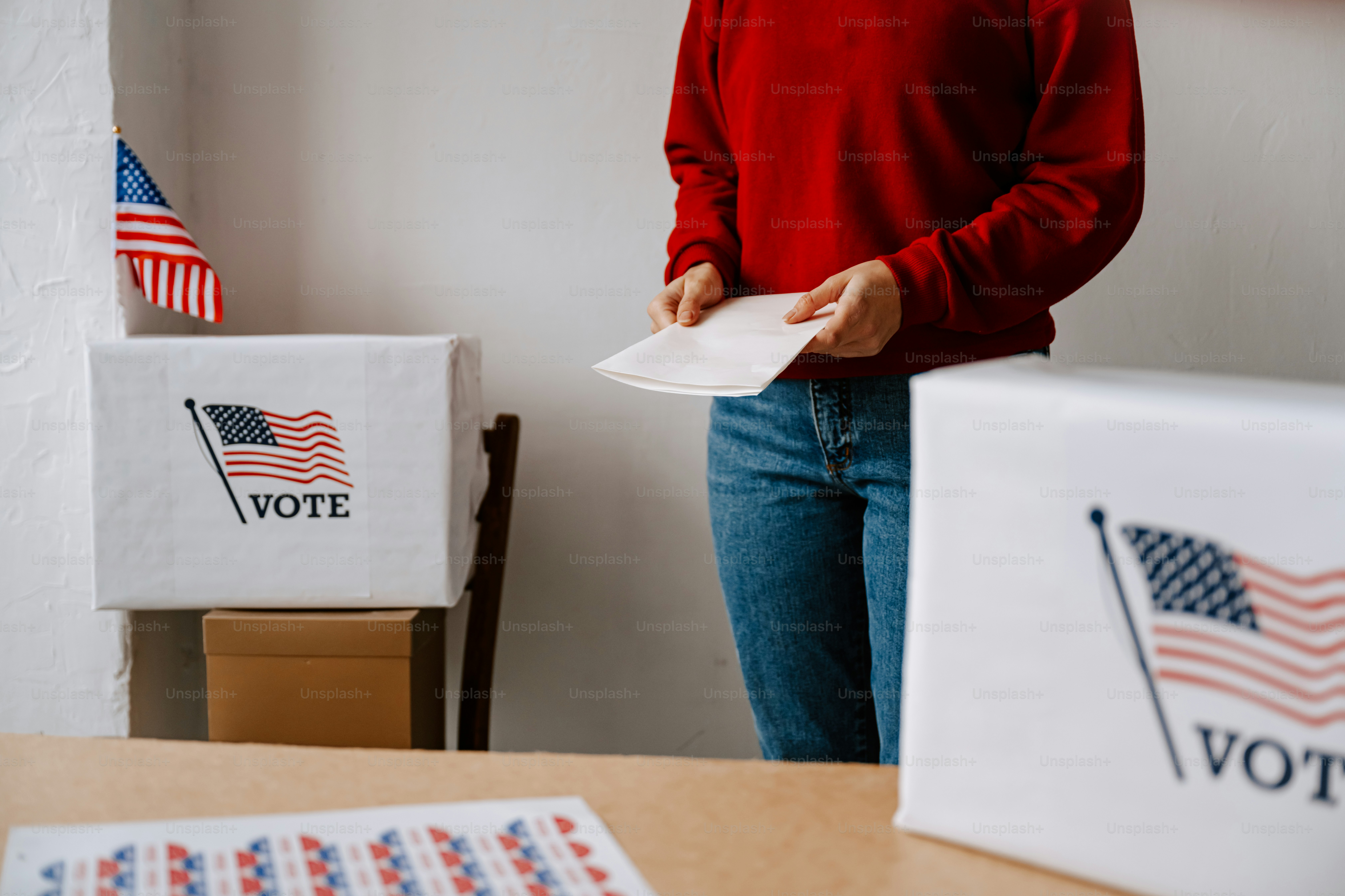 A woman standing in front of a voting machine