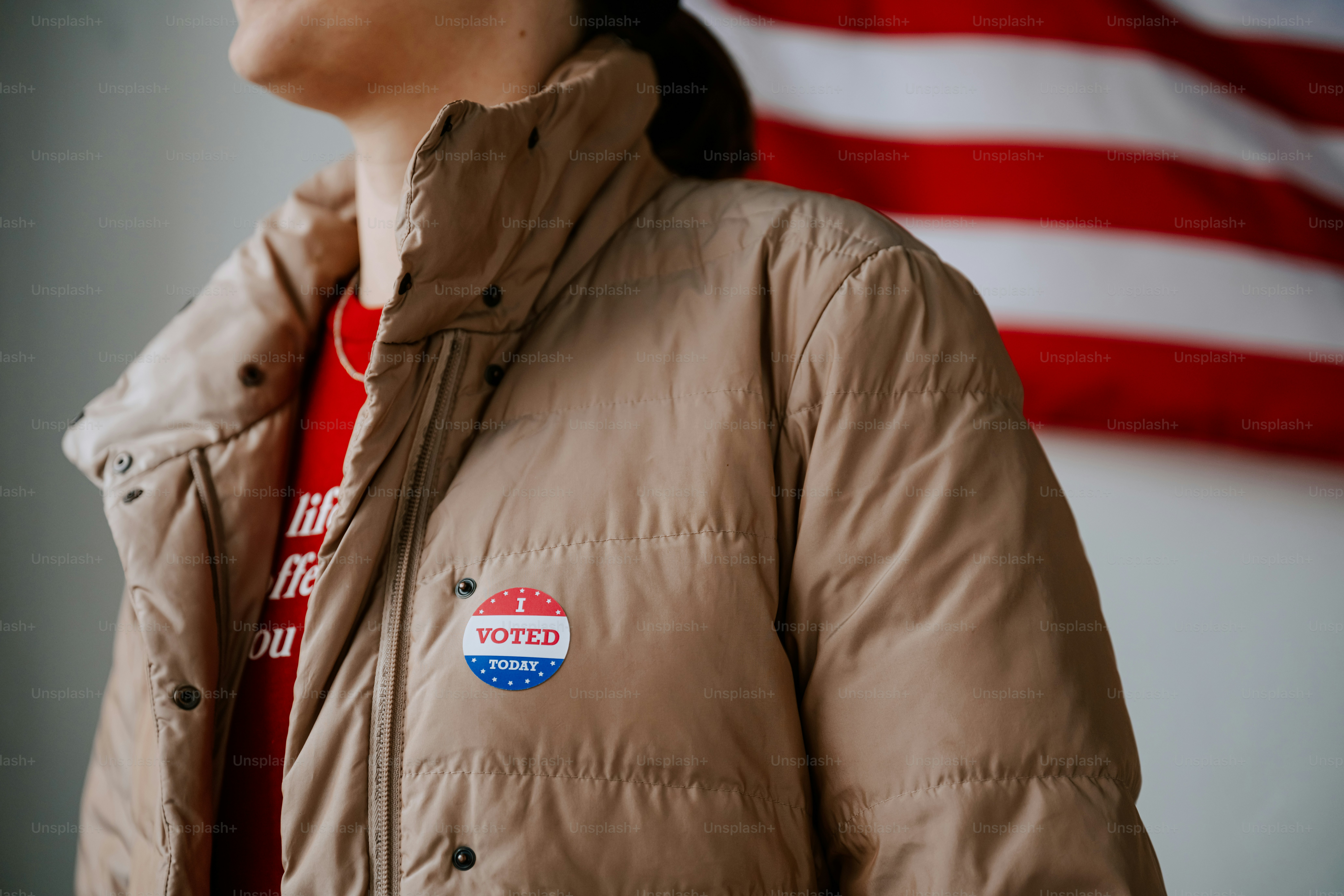 A woman standing in front of an american flag