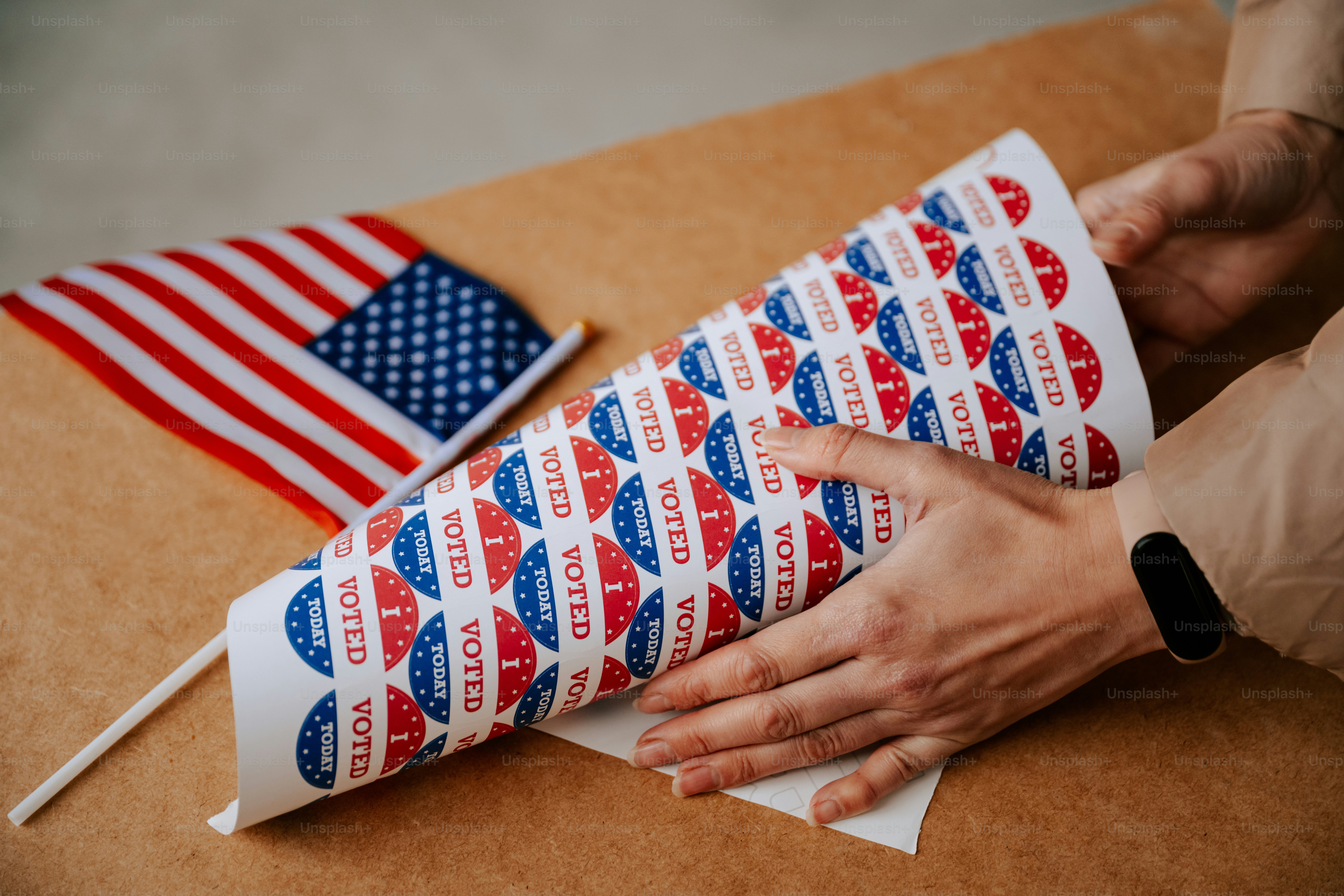 A person is wrapping a flag on a cardboard box