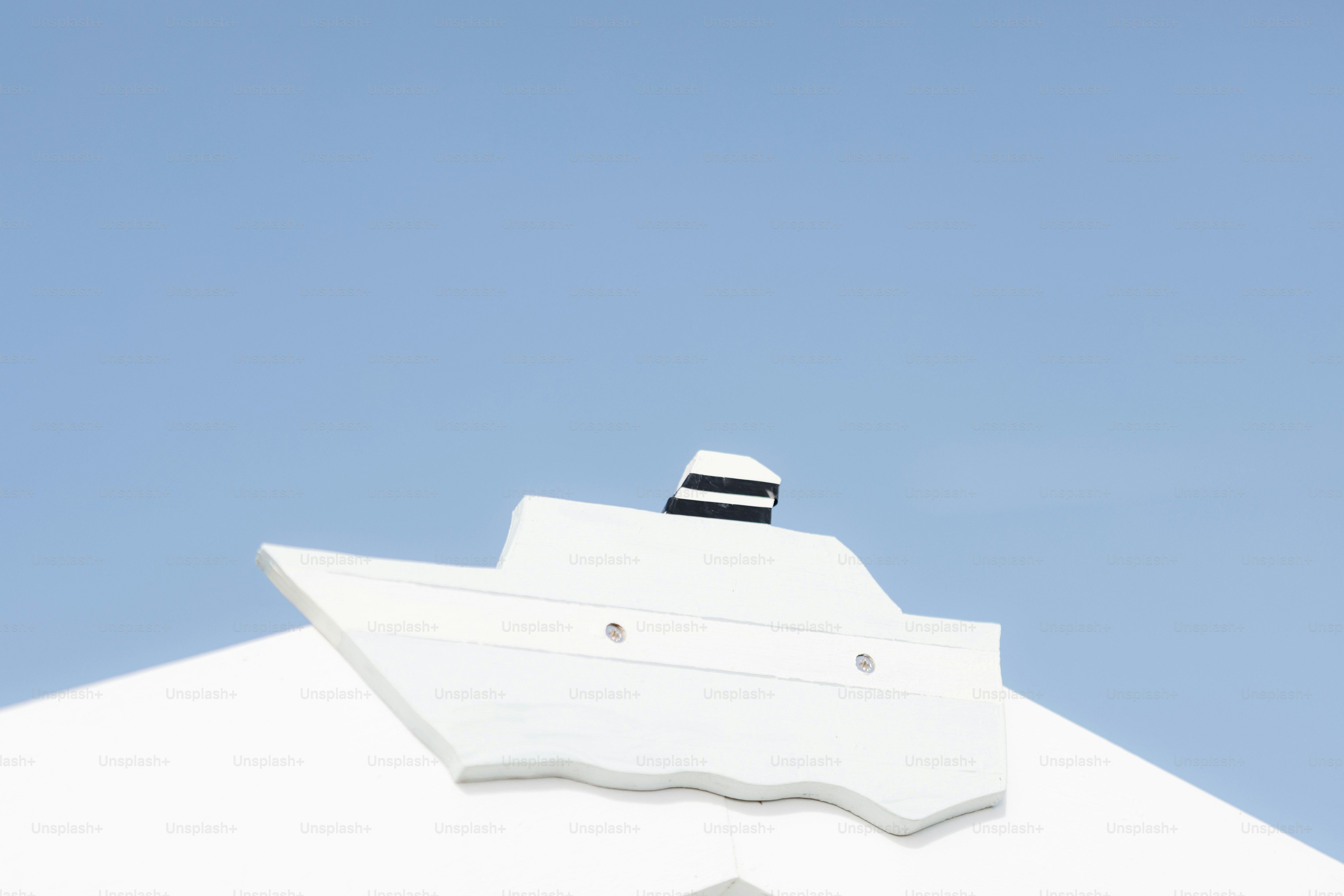 A white building with a clock on the top of it