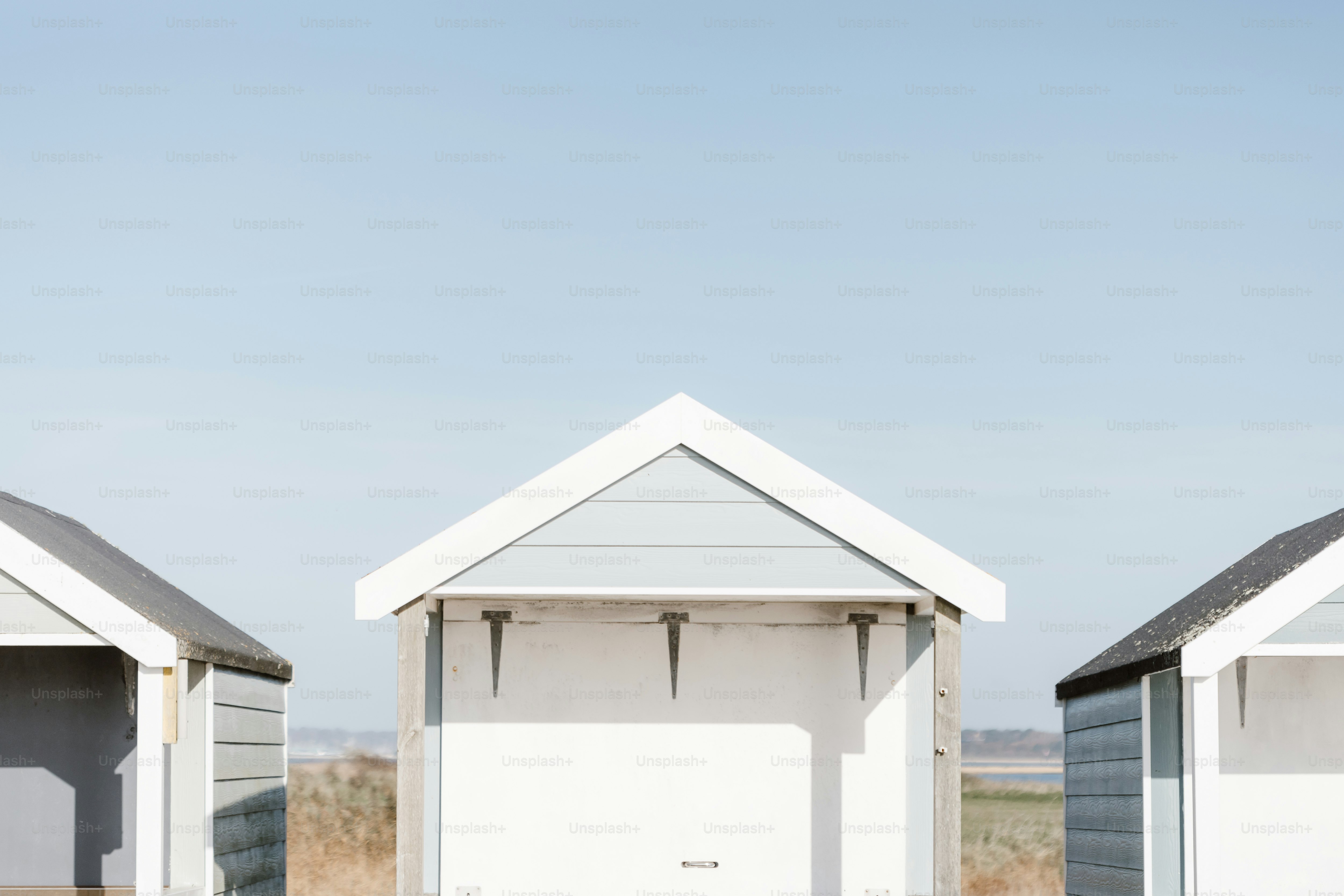 A row of beach huts sitting next to each other