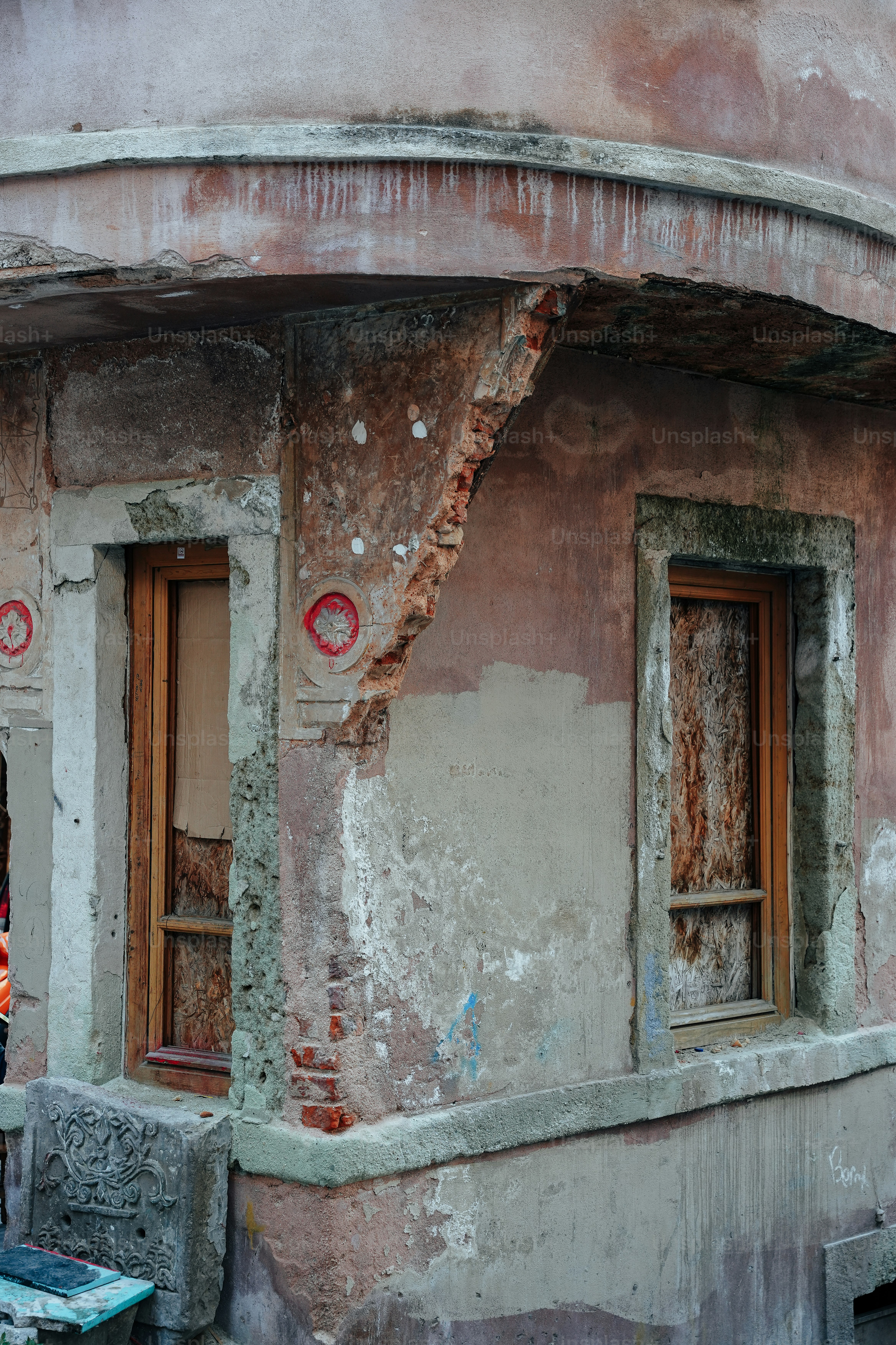 A man standing outside of a run down building