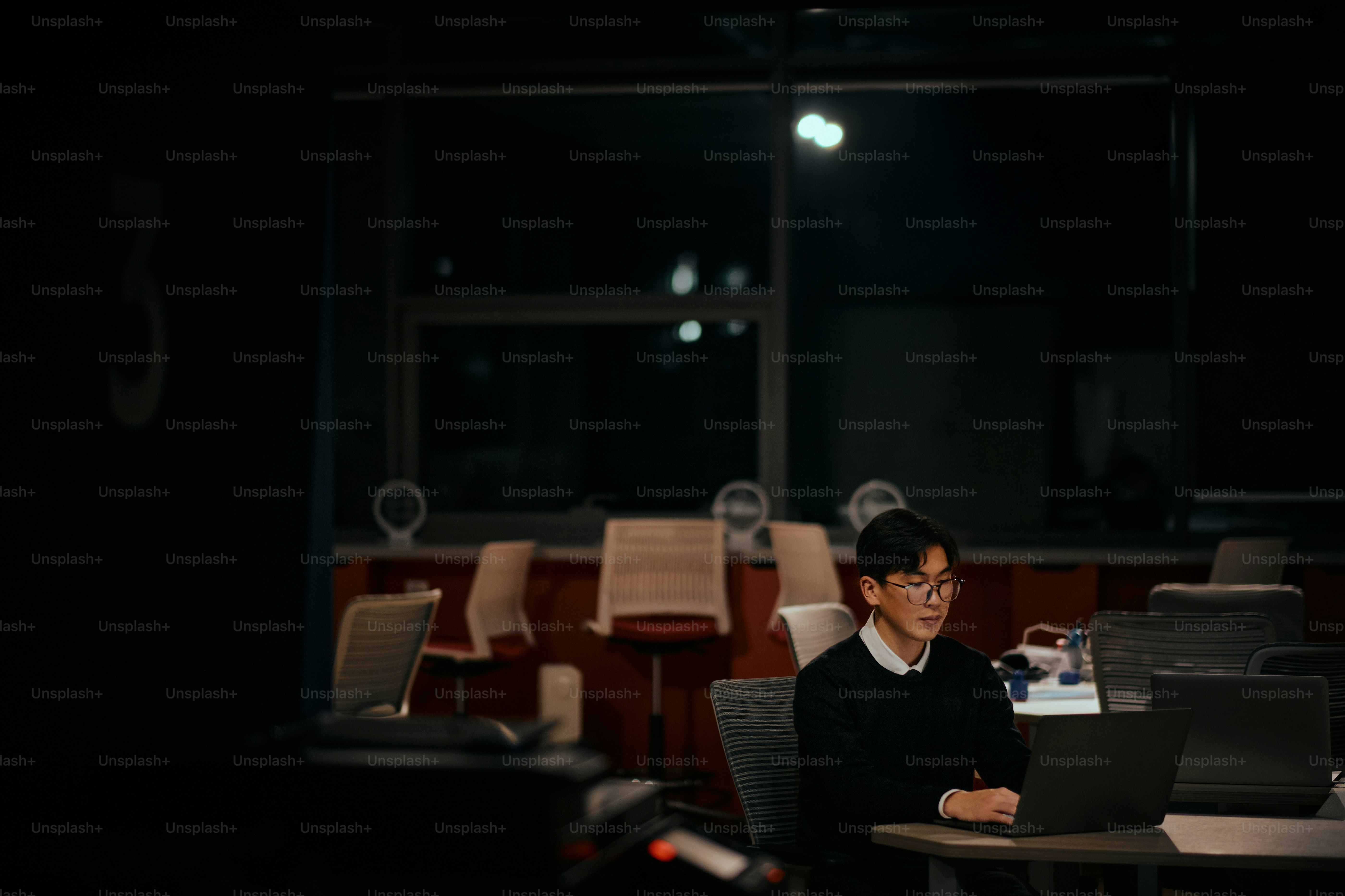 A person sitting at a desk with a laptop