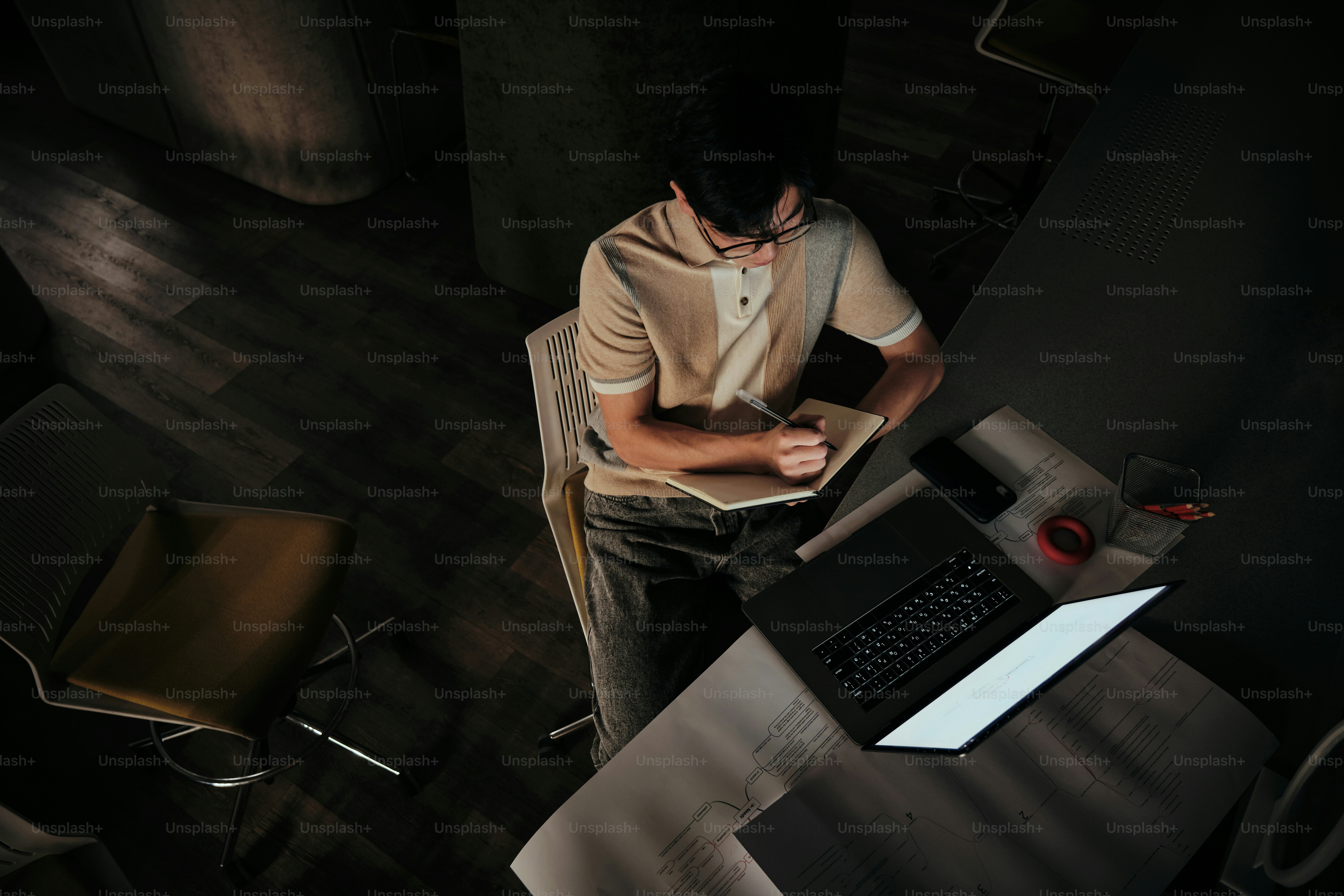 Ein Mann, der mit einem Handy an einem Tisch sitzt