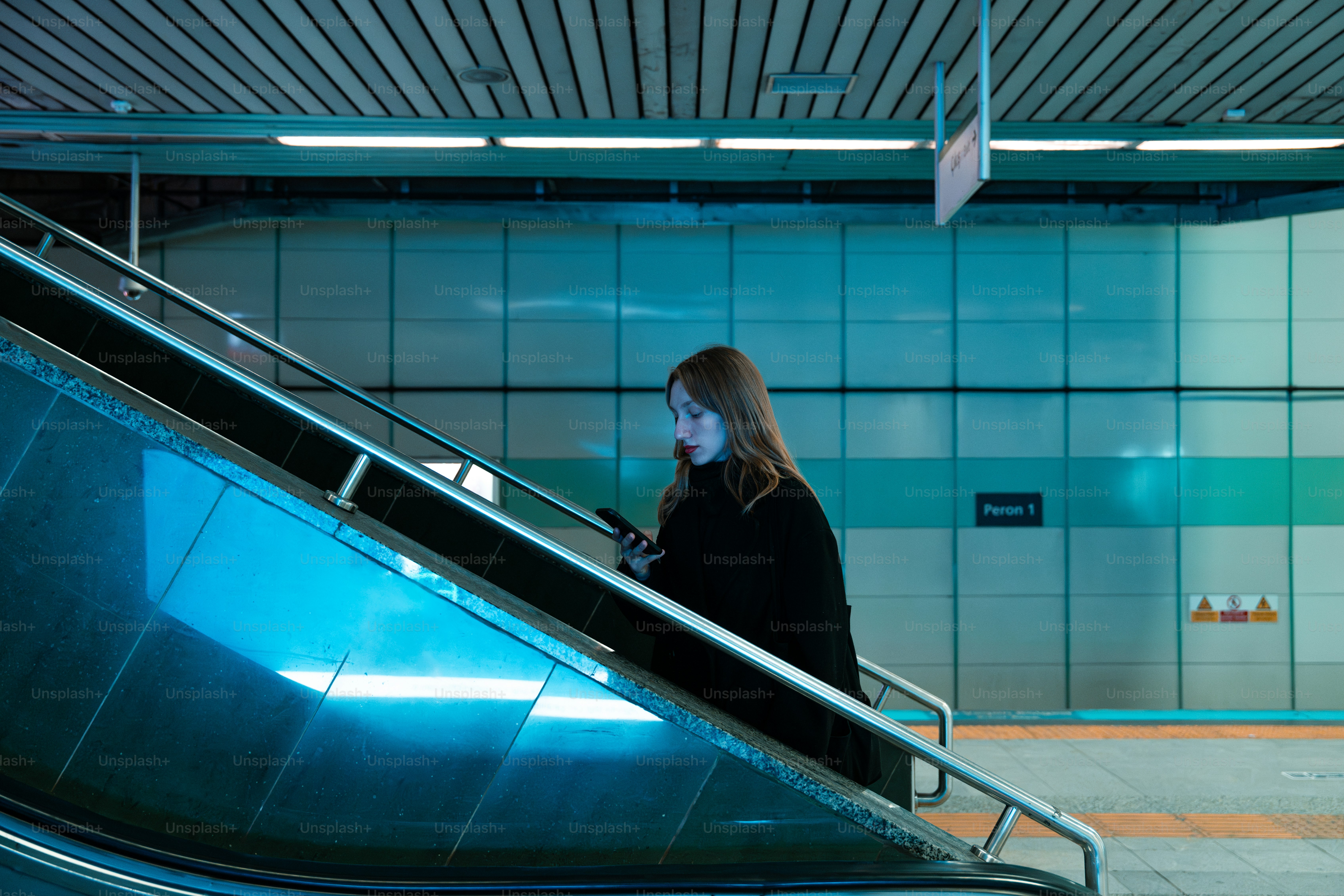 A woman wearing a face mask riding an escalator