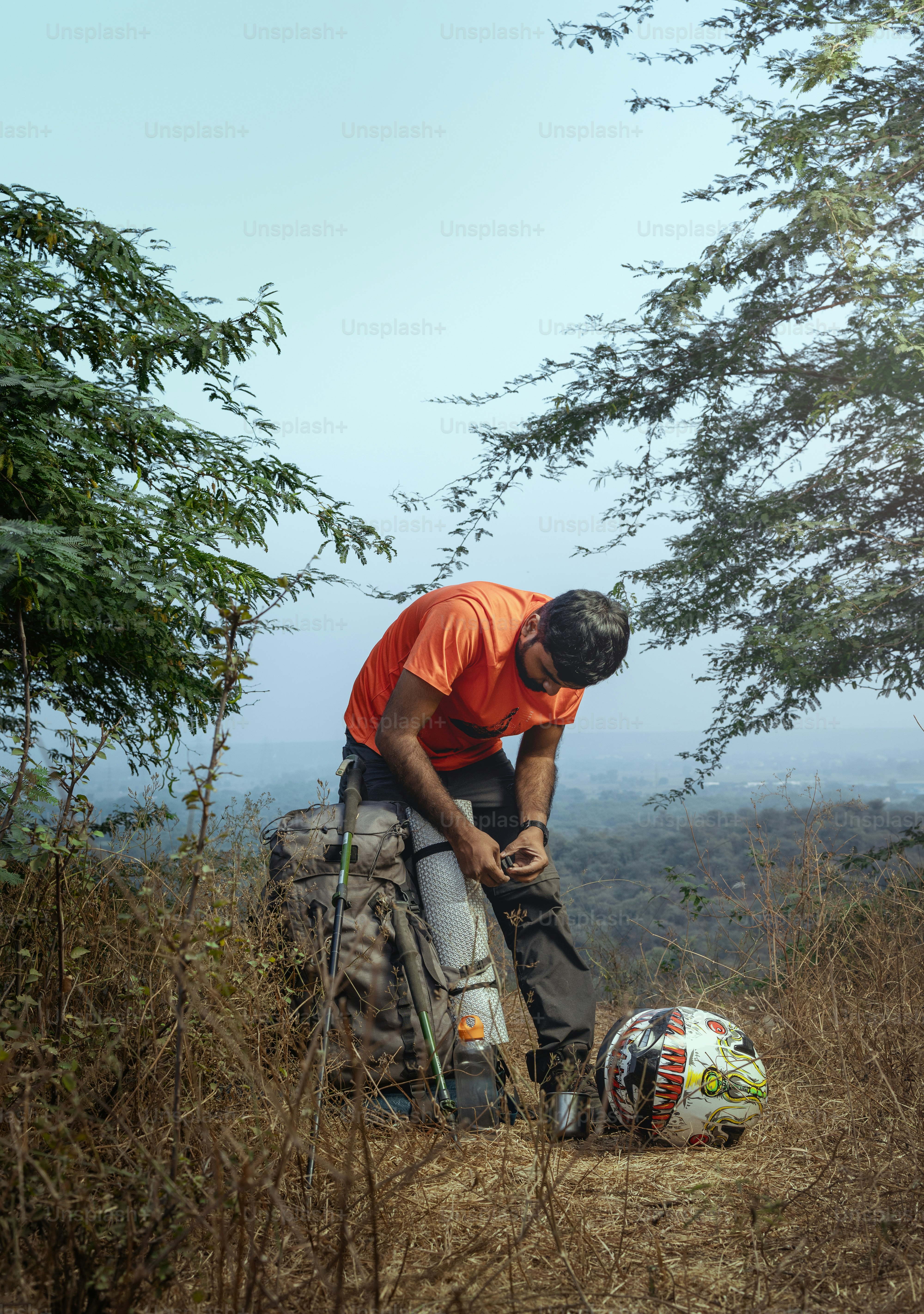 Solo trekker awaiting search and rescue insurance evacuation in remote mountains