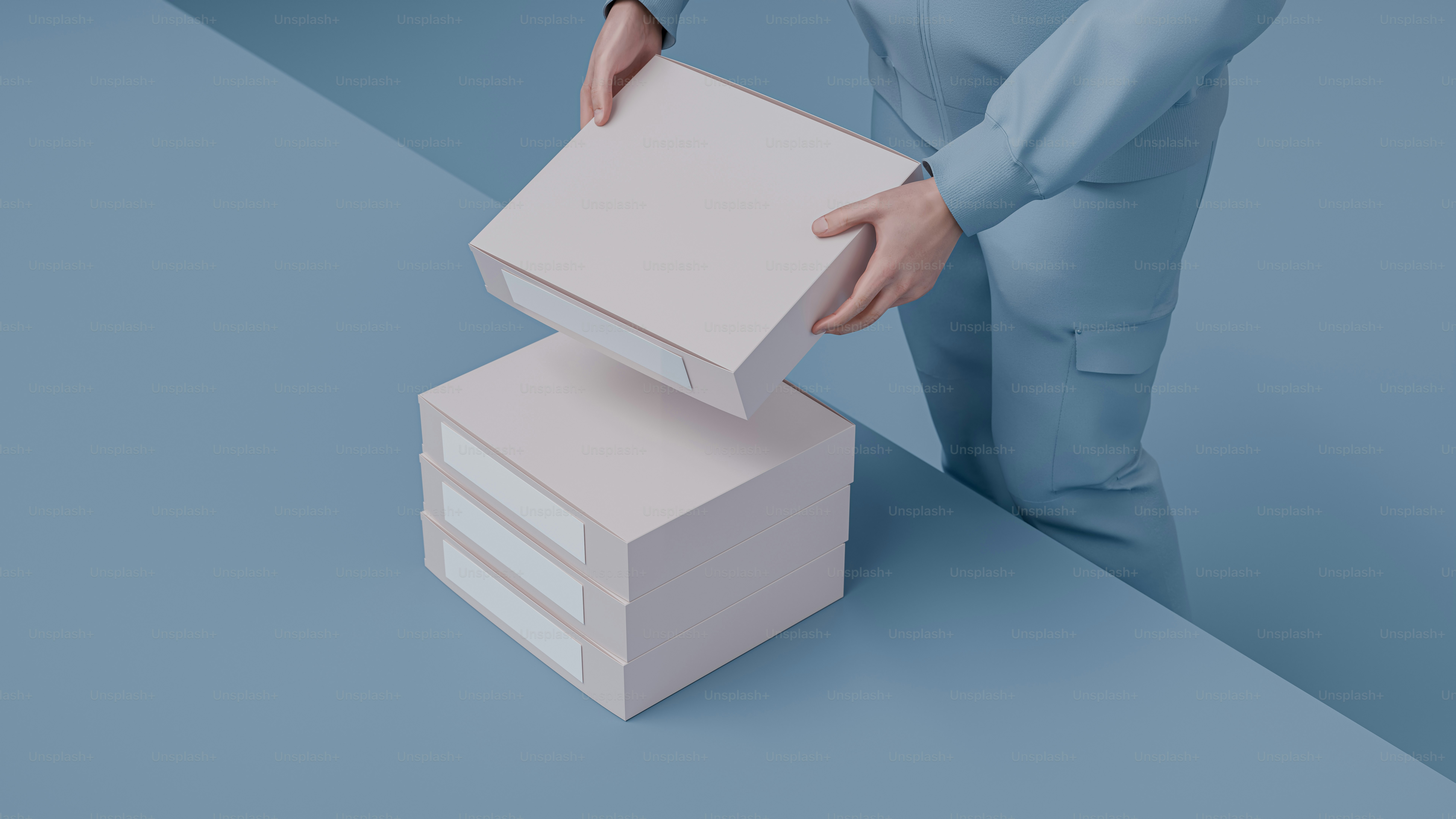 A man in a blue suit holding a white box photo – Product Image on Unsplash