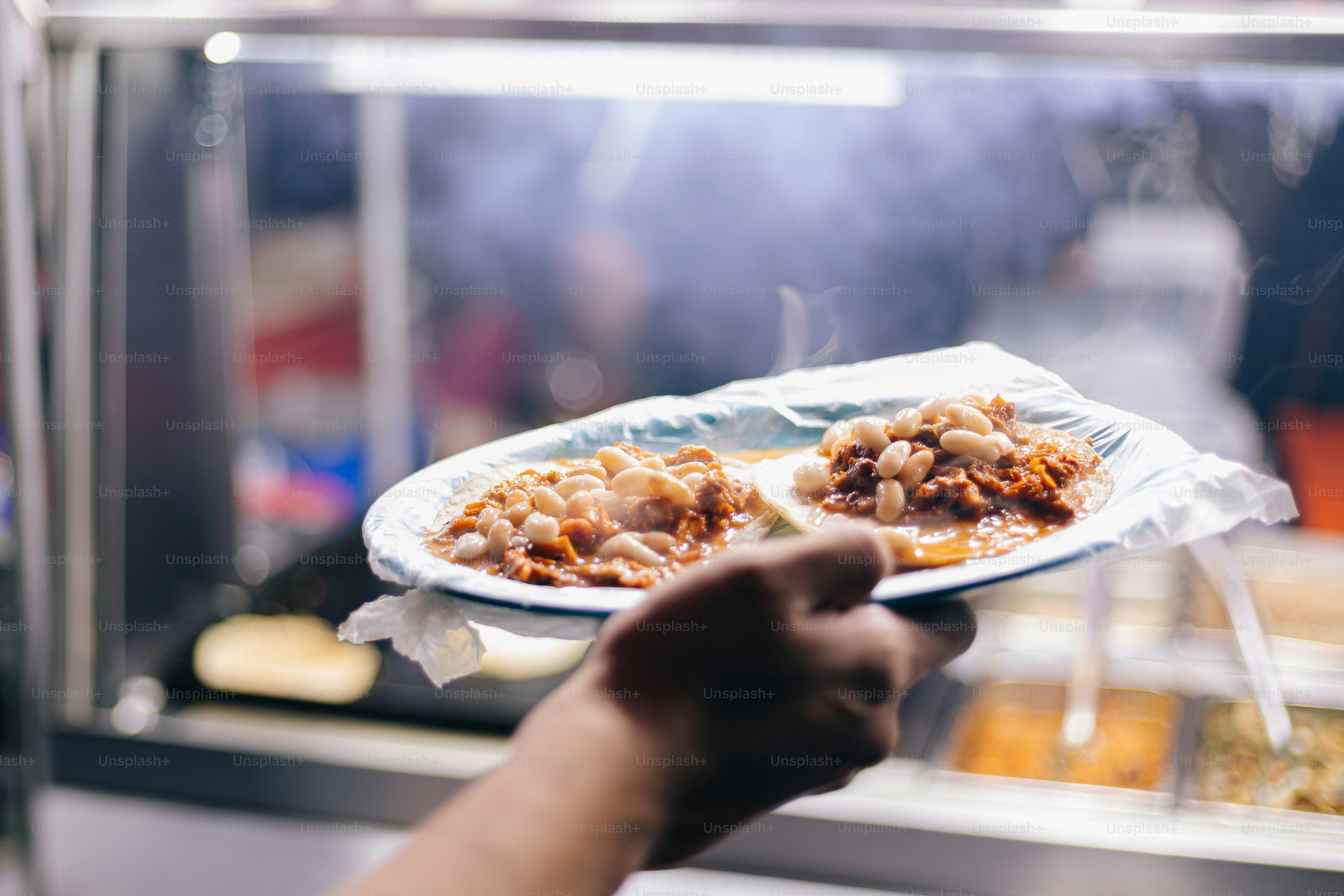 A person holding a plate with food on it