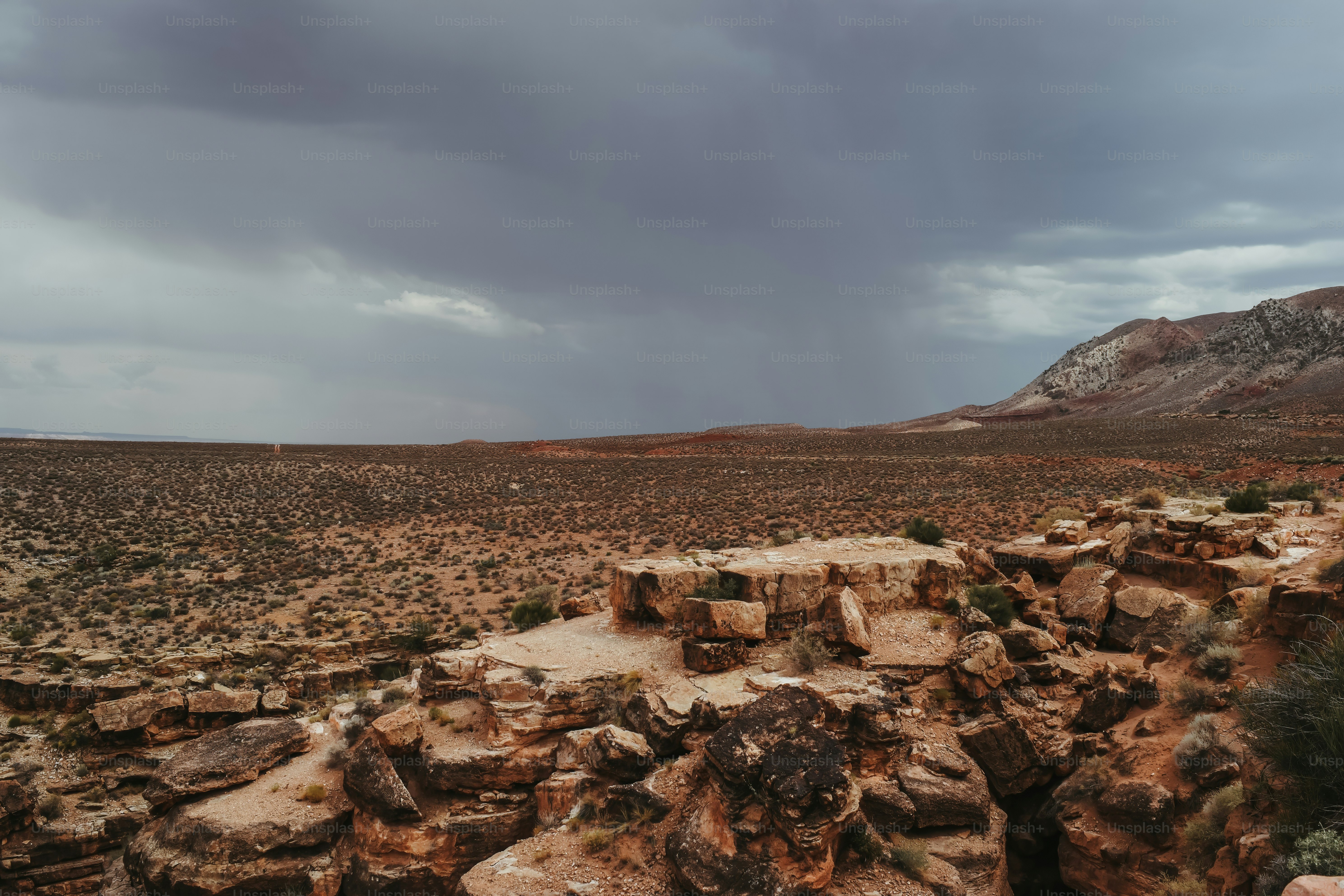 A rocky outcropping in the desert under a cloudy sky