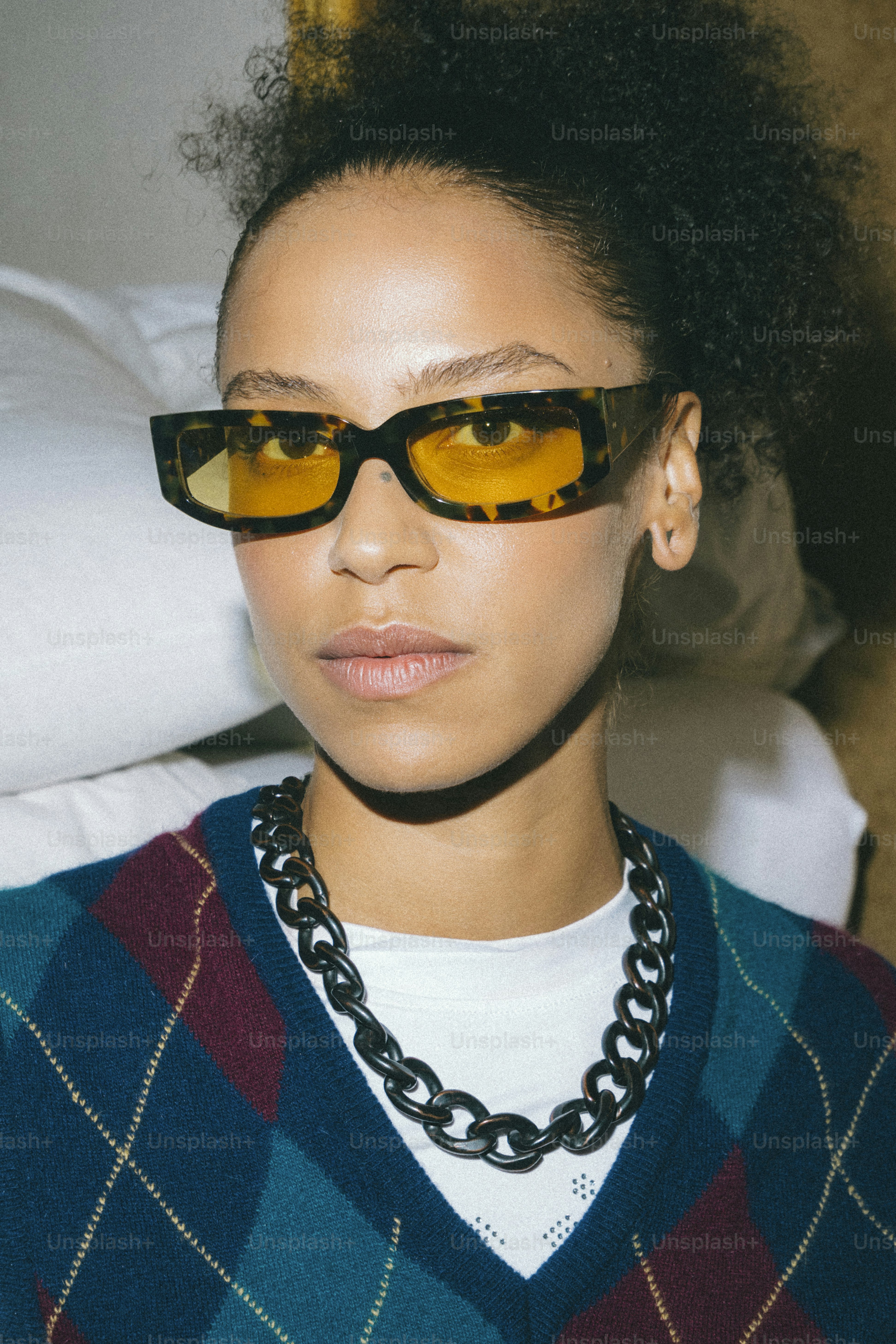 A woman wearing sunglasses and a sweater