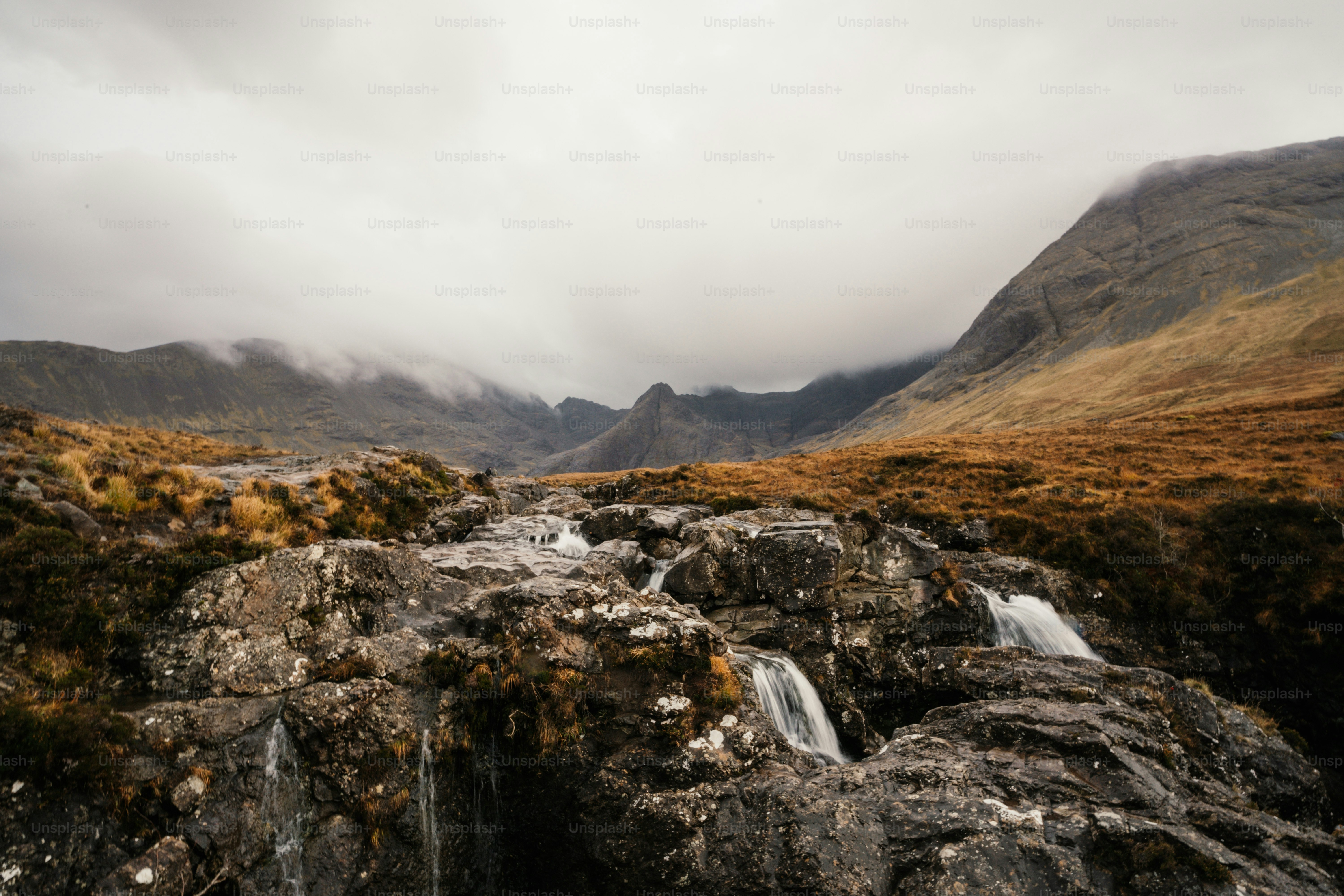 A waterfall in the middle of a mountain range