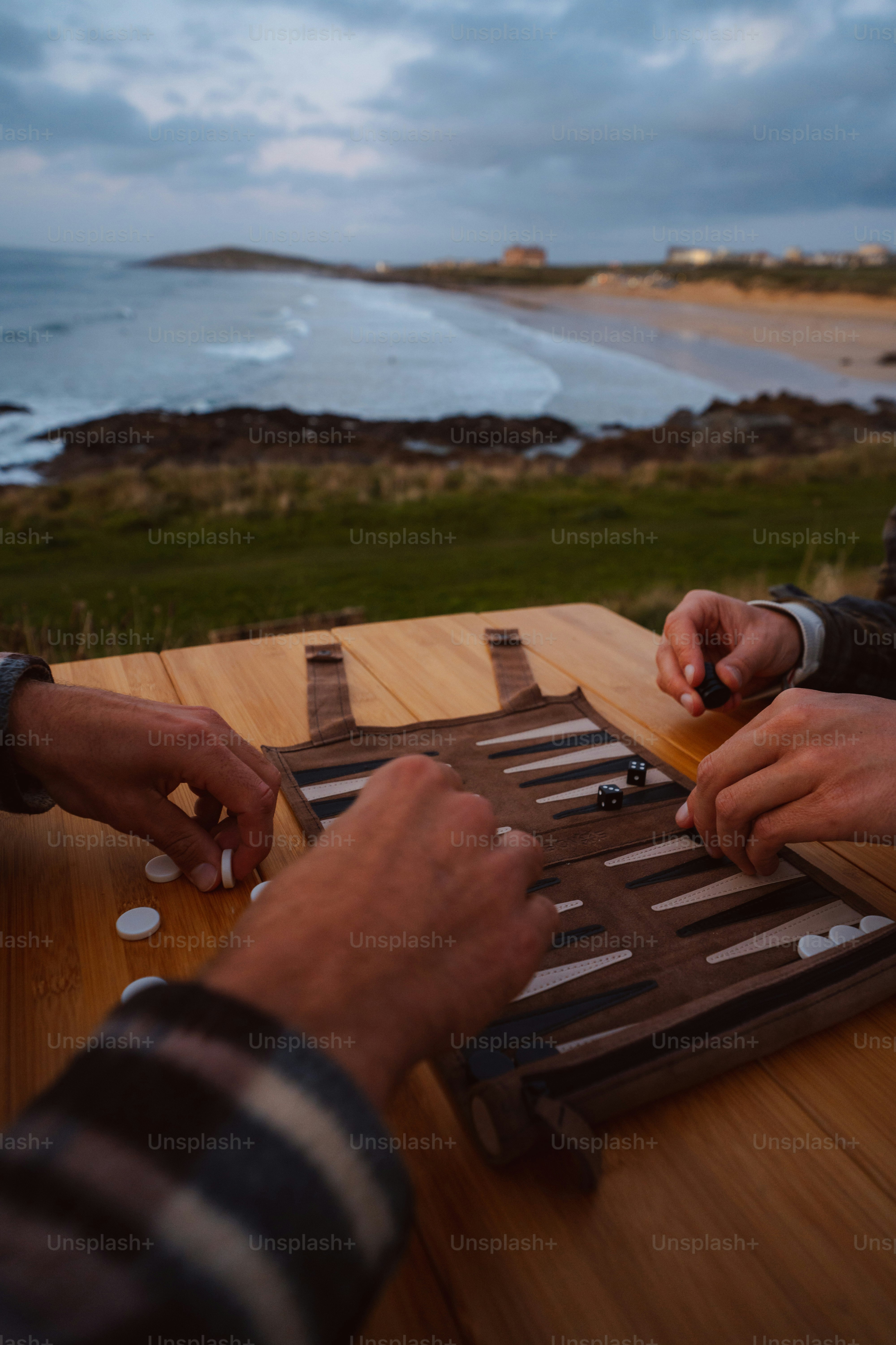 A couple of people sitting at a table playing a game