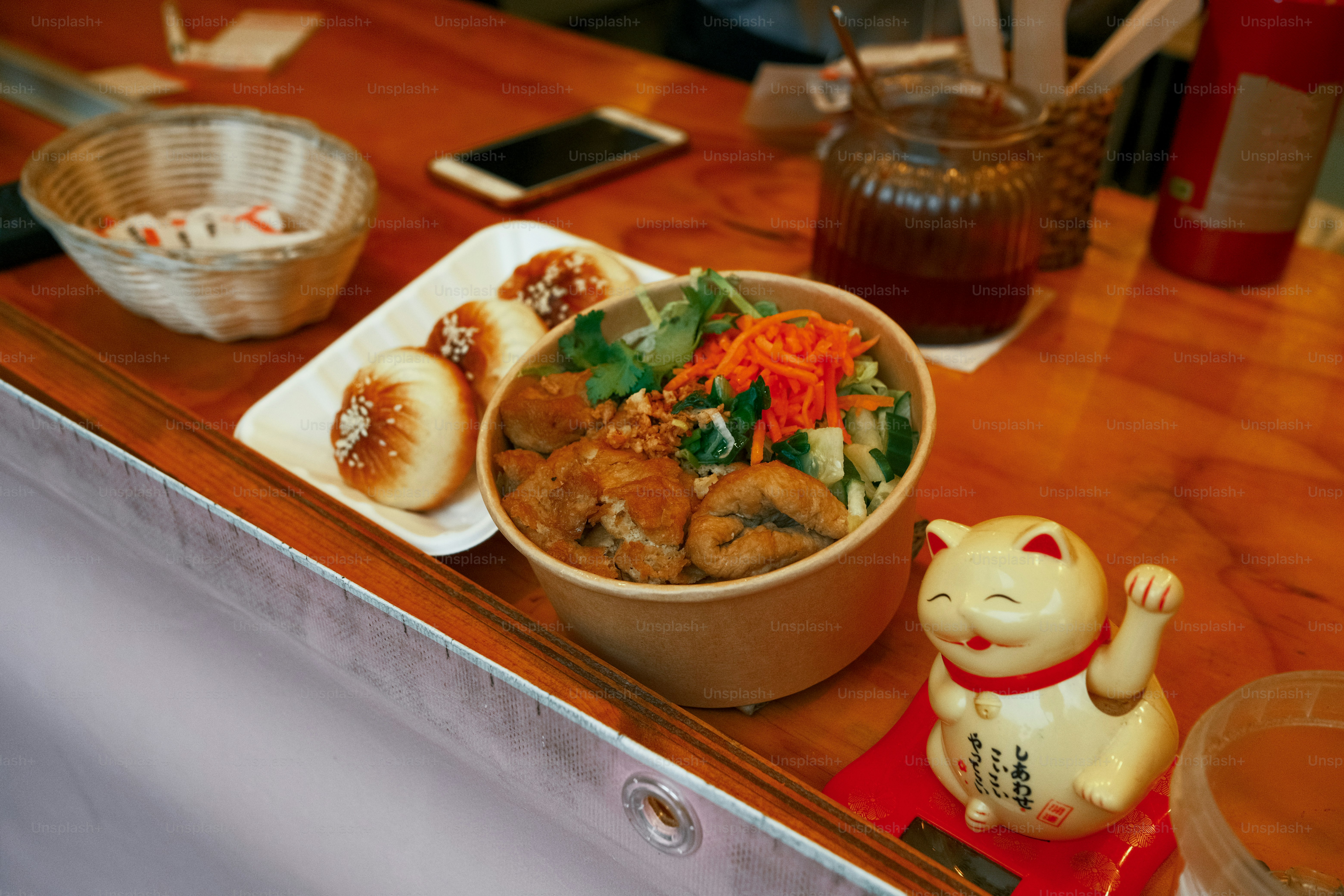 A wooden table topped with a bowl of food